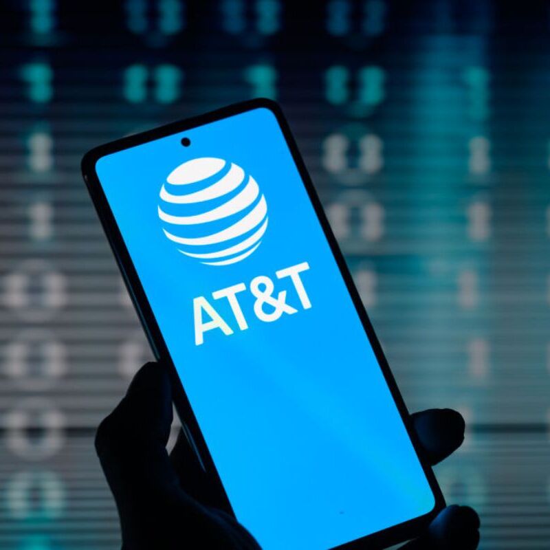 Man being interviewed and AT&amp;T logo on smartphone