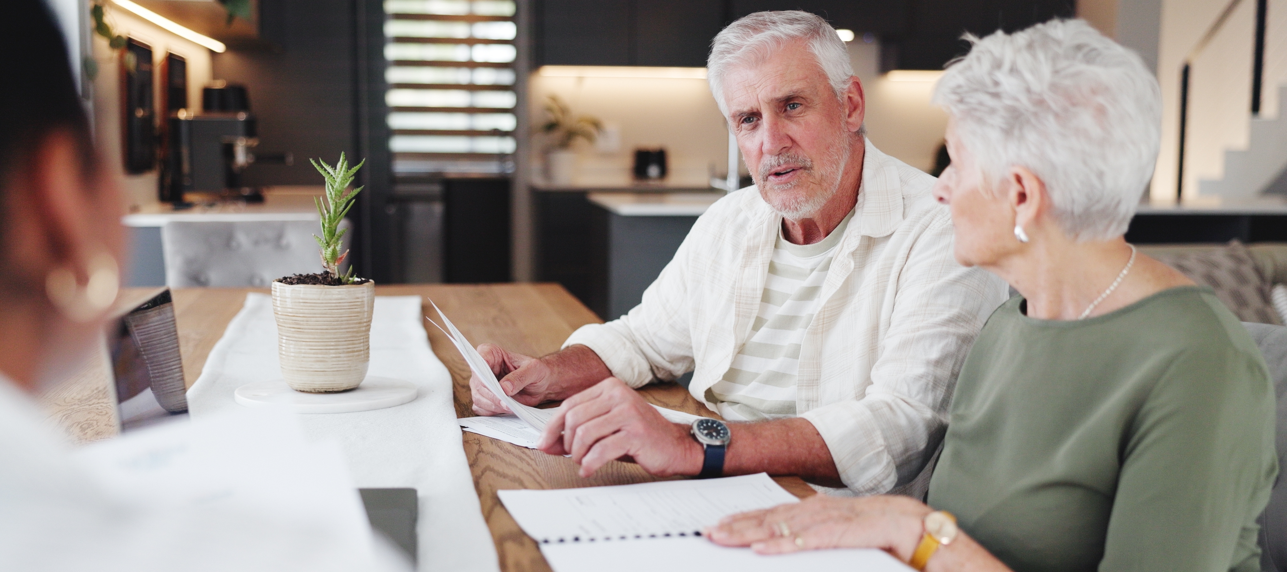 Senior couple discussing retirement options with financial advisor.
