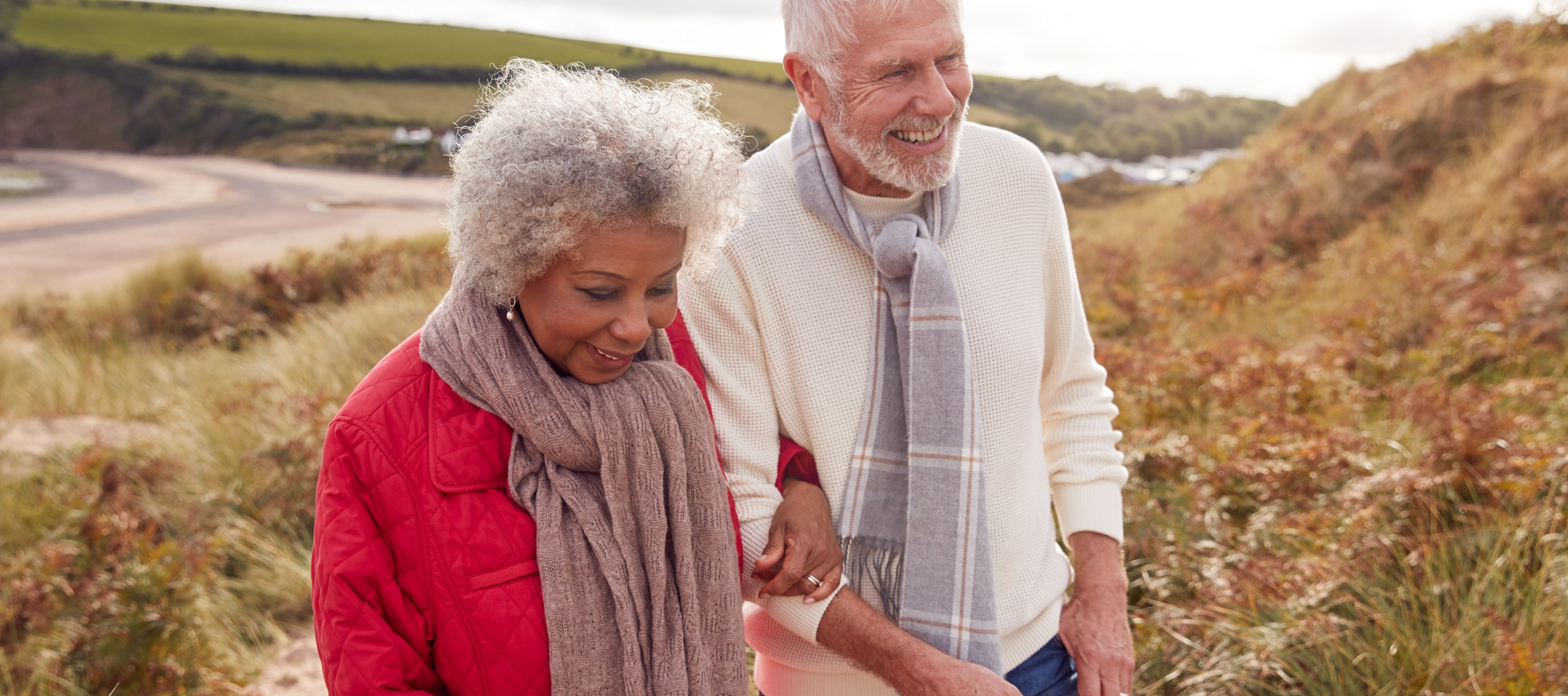 Retired couple happily hiking.