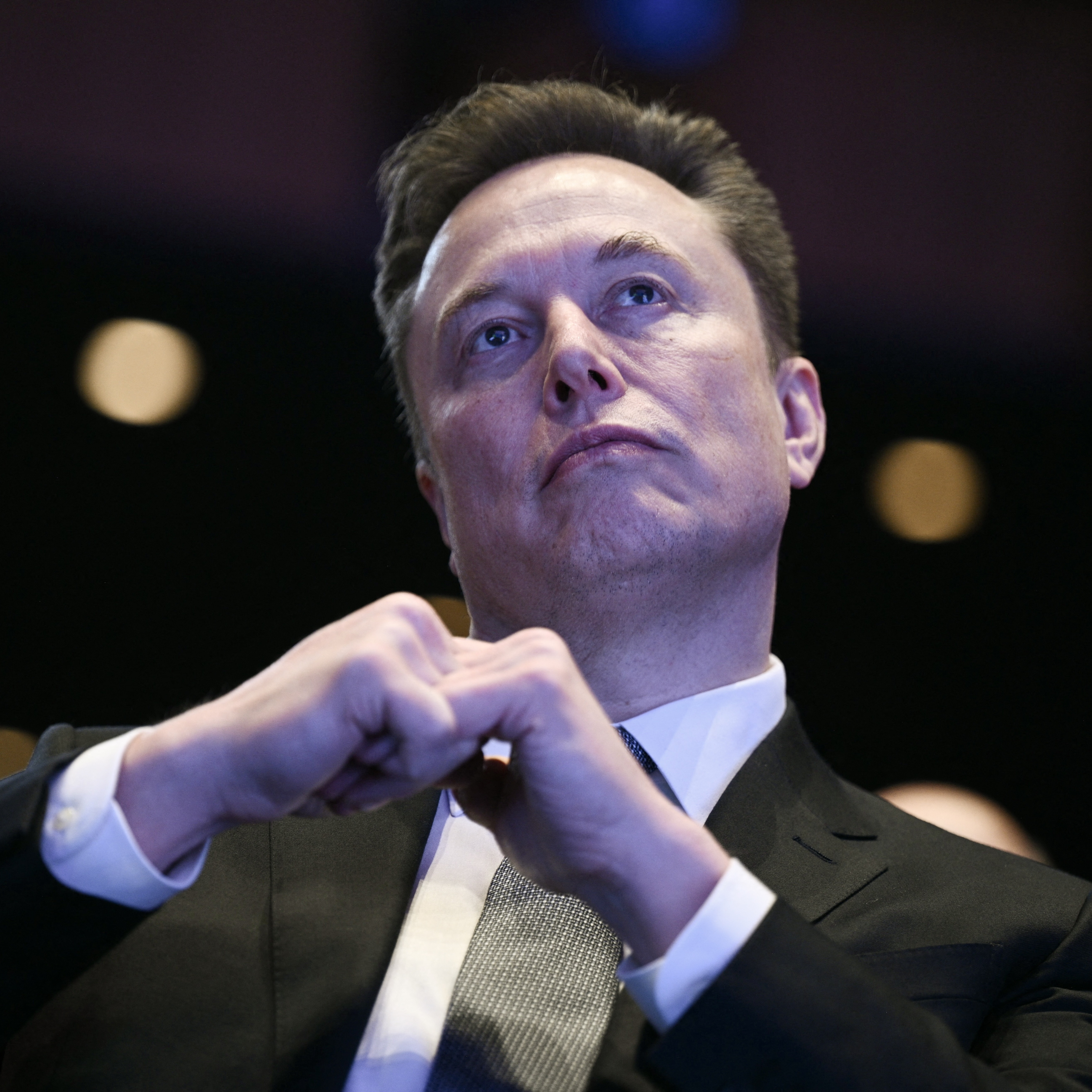 Elon Musk looks on as US President Donald Trump speaks at the US-Saudi Investment Forum in Washington, DC on November 19, 2025.
