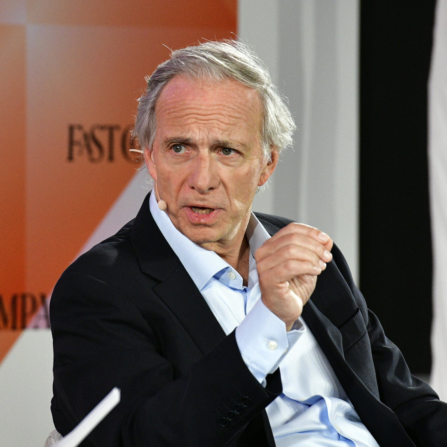 Ray Dalio pinches two fingers together and looks intensely into the camera.