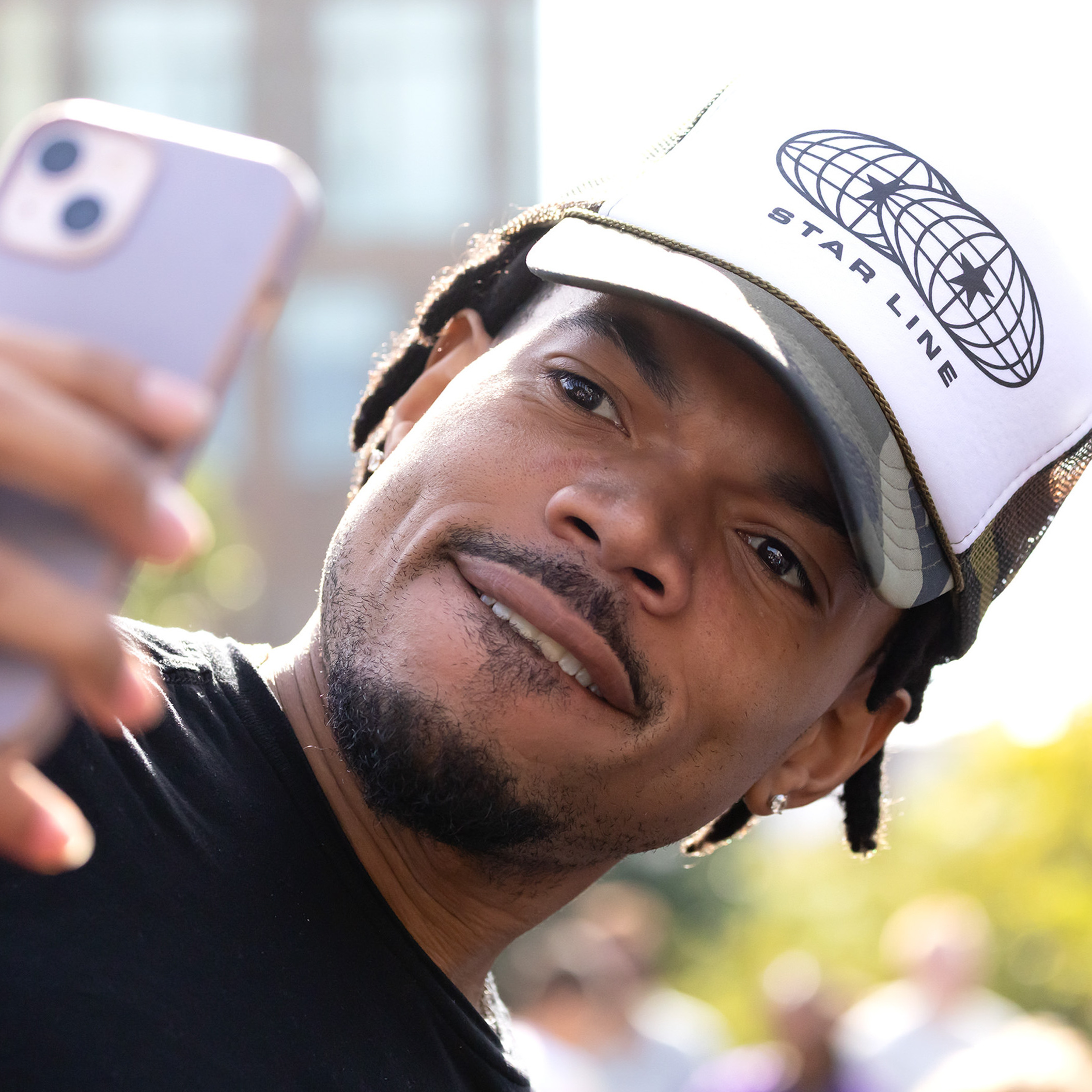 Chance the Rapper taking a photo on an iPhone
