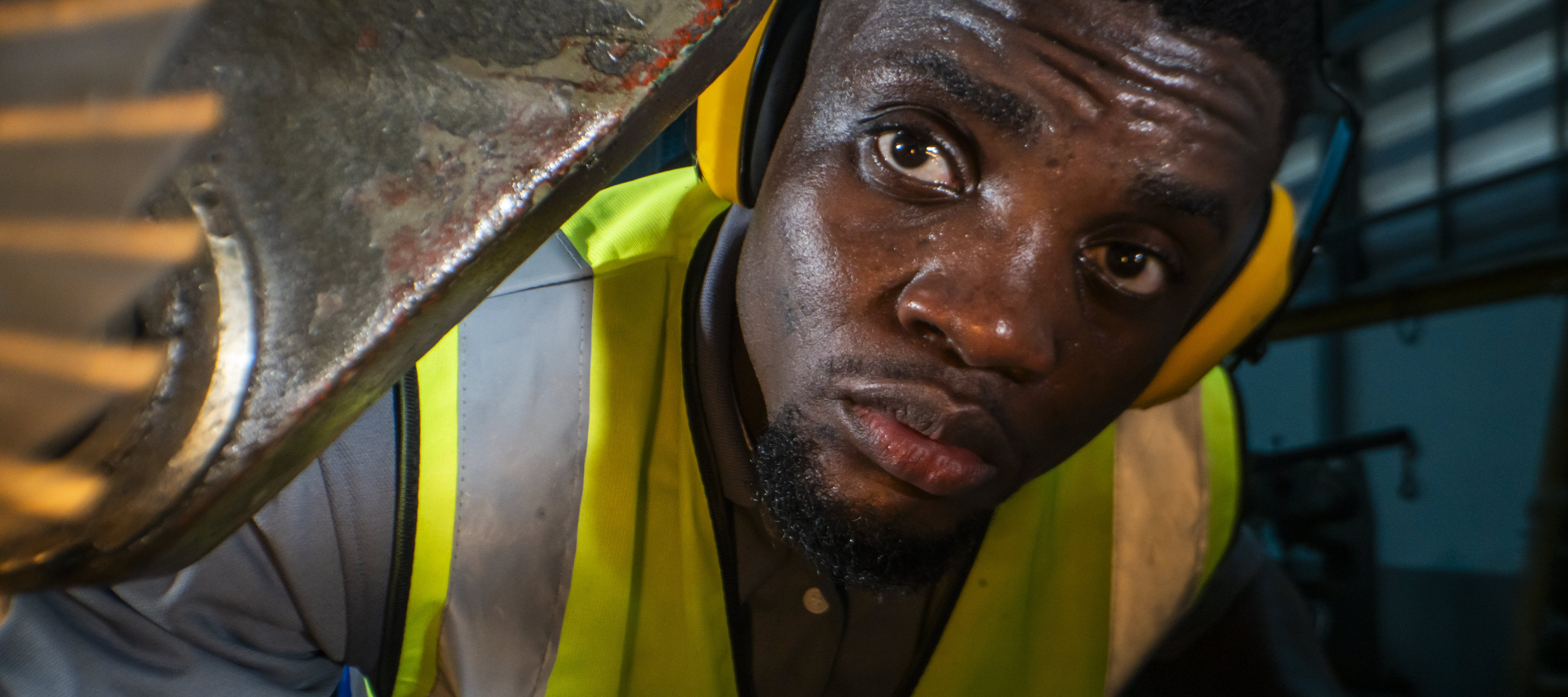 A factory worker operates heavy machinery.