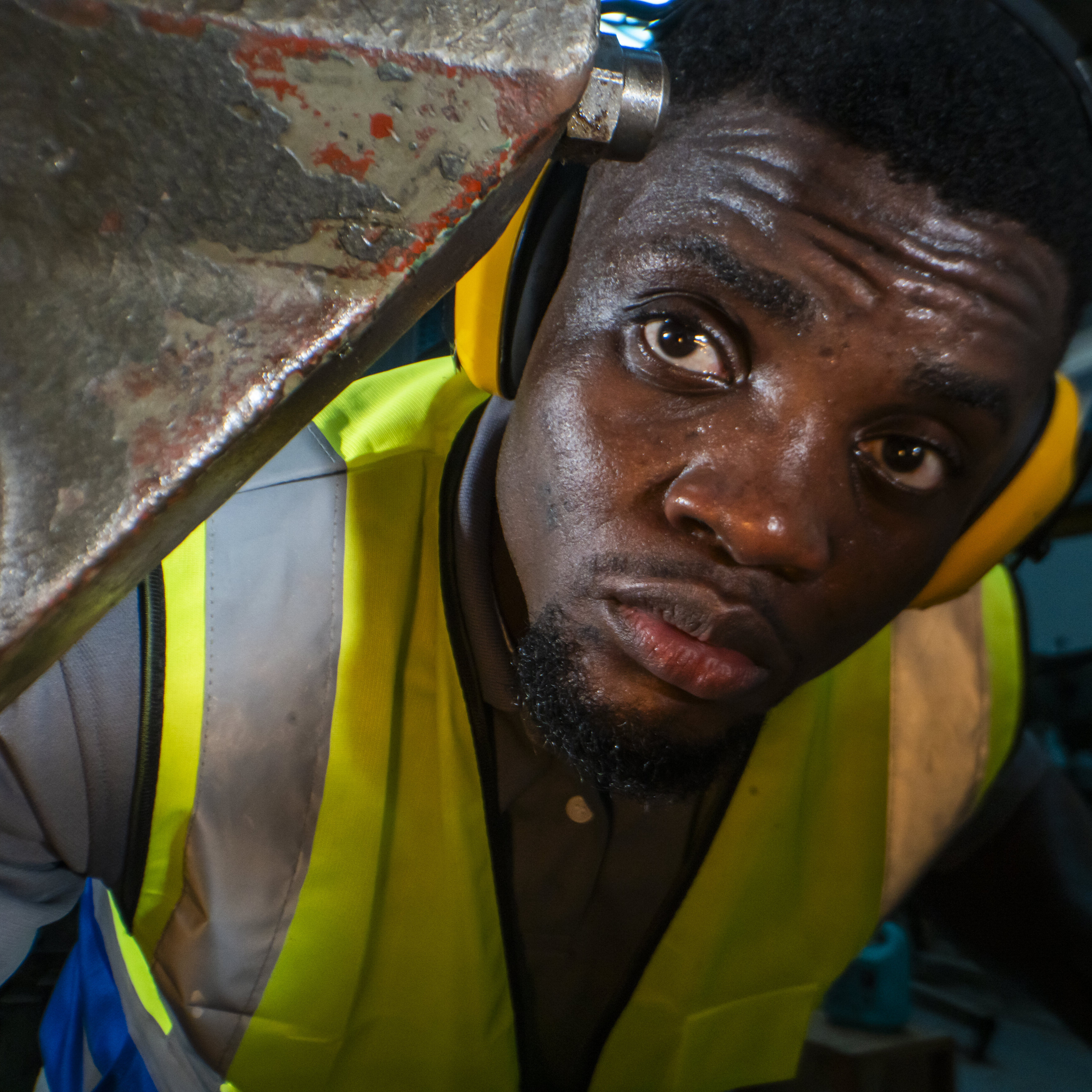 A factory worker operates heavy machinery.