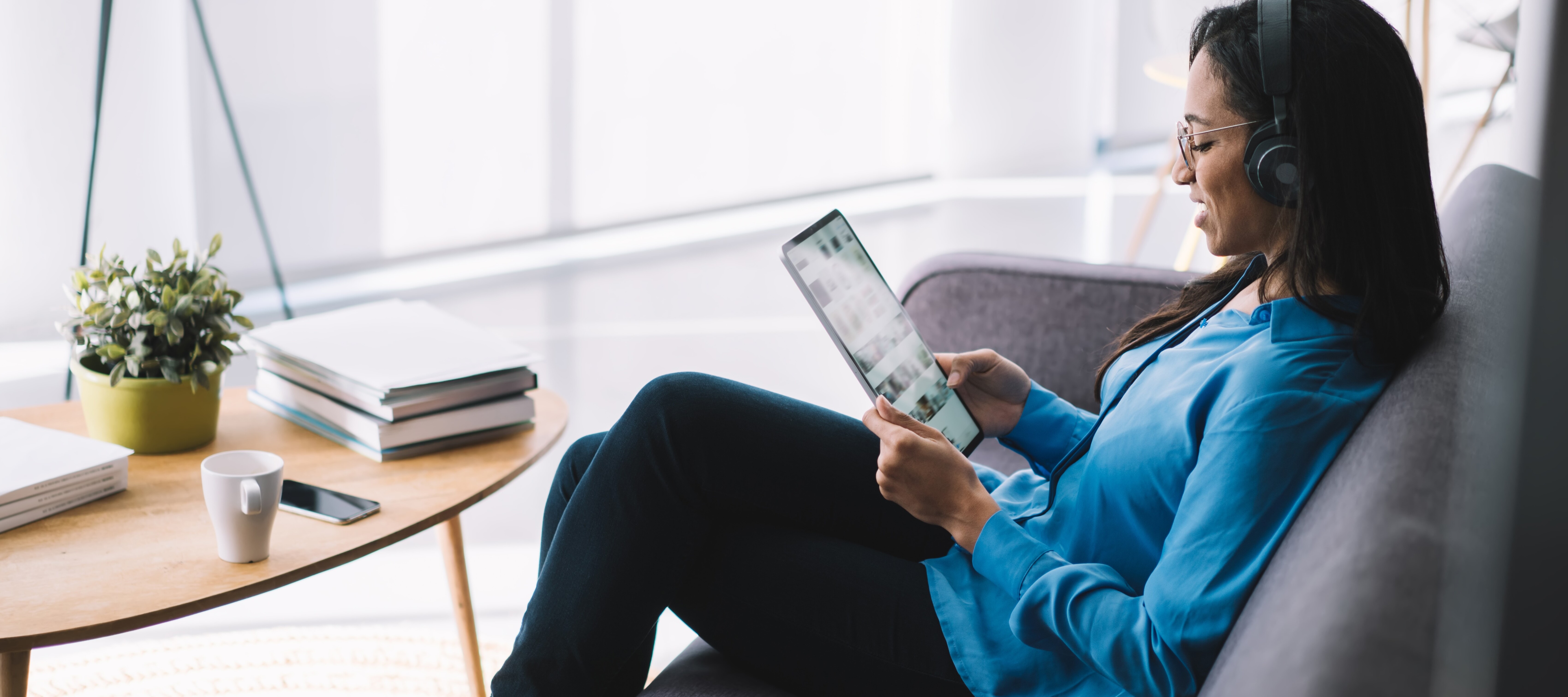 Woman reading email newsletter on a tablet.