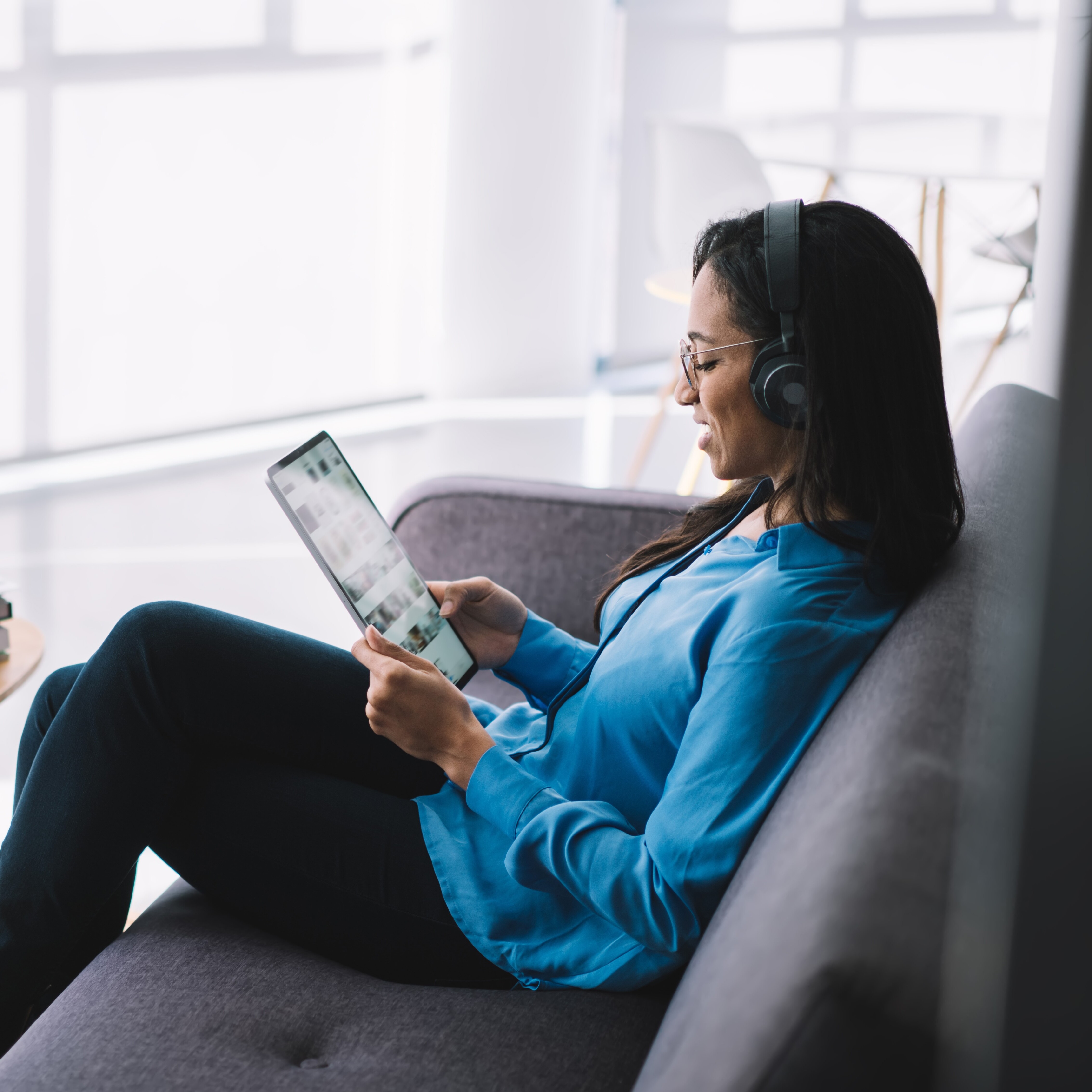 Woman reading email newsletter on a tablet.
