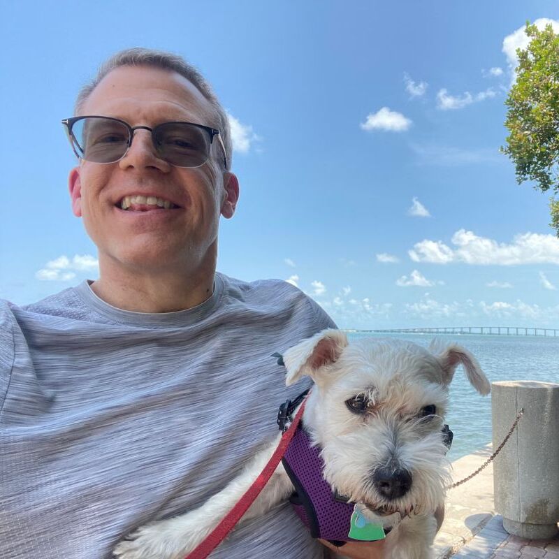 Image of man with dog next to image of New York City skyline