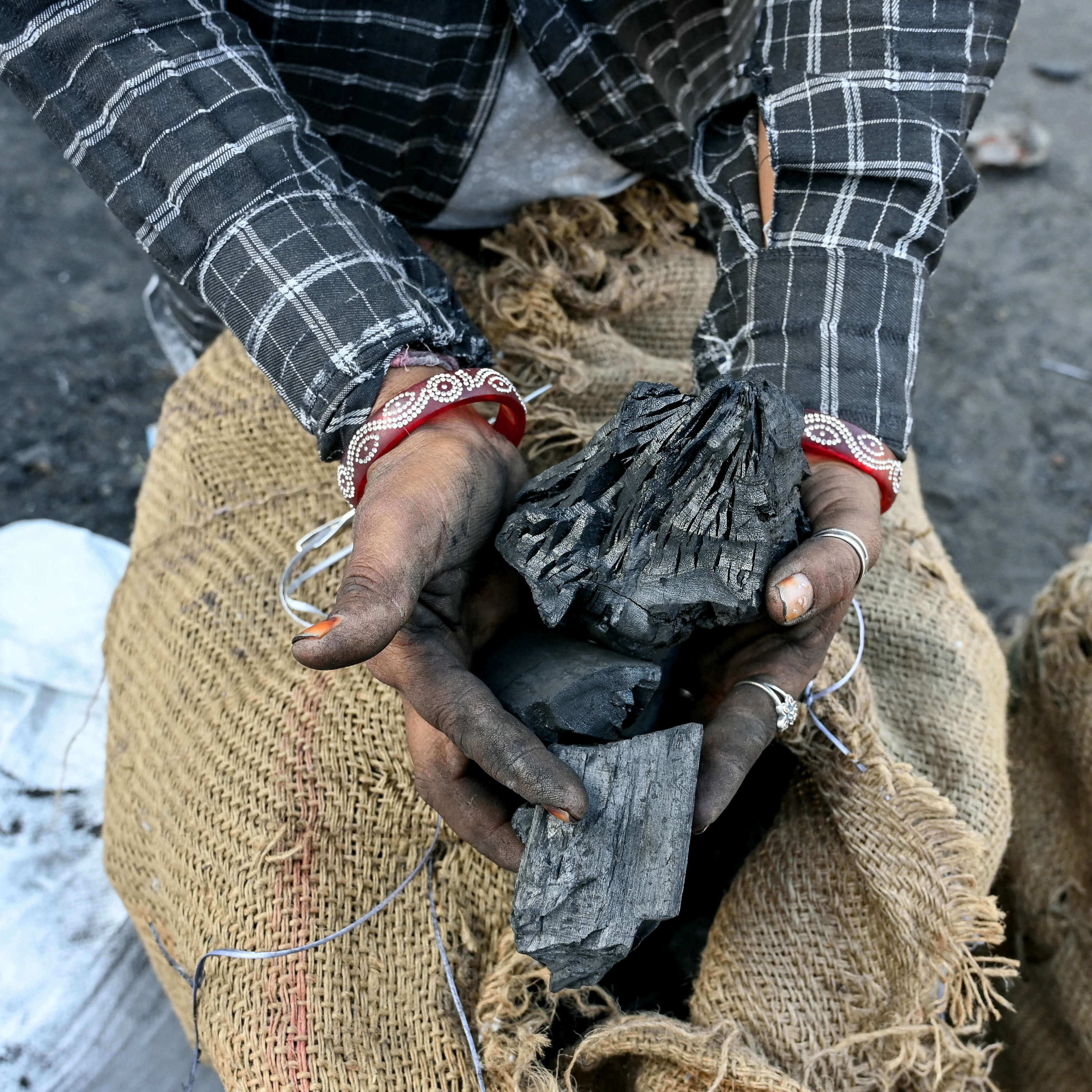 Laborer holds coal.
