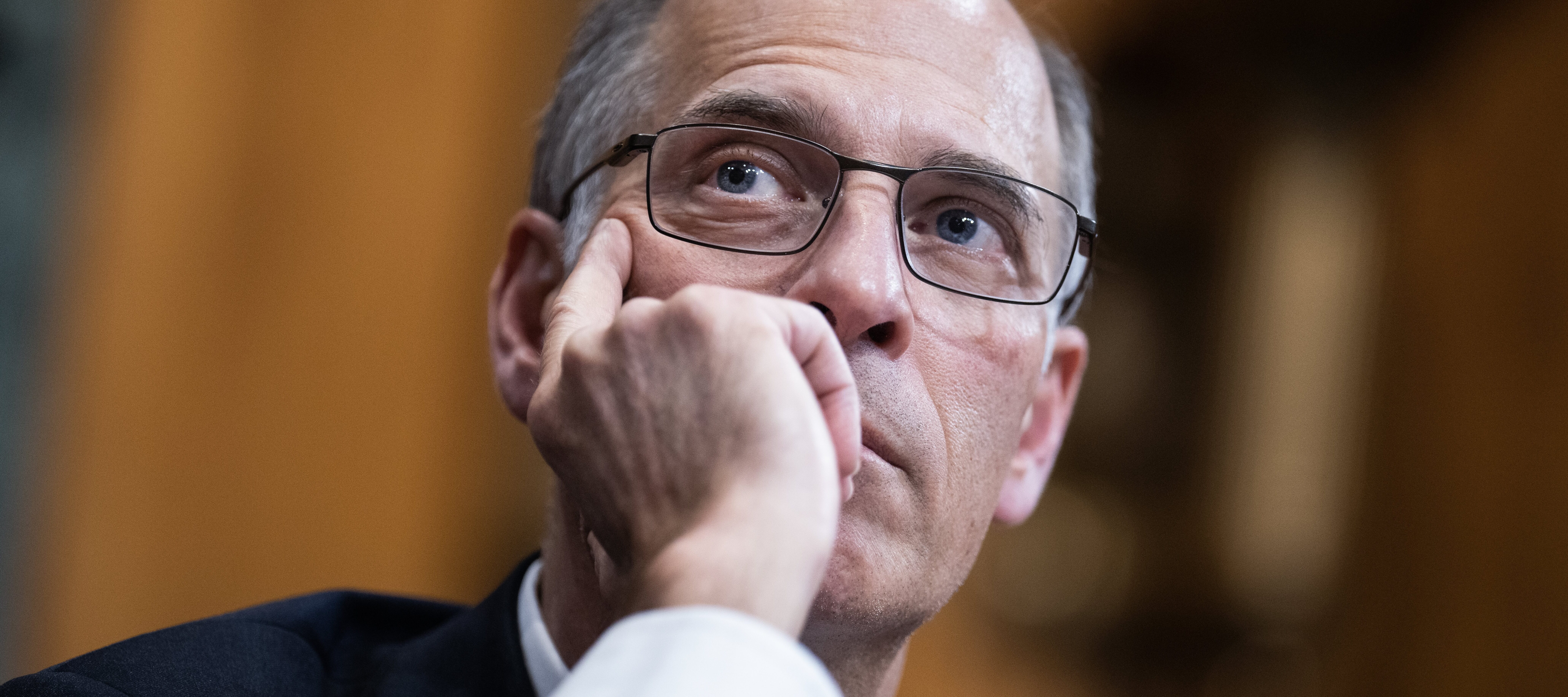 Moody's Economist Mark Zandi presses one hand into the side of his cheek, thinking deeply.