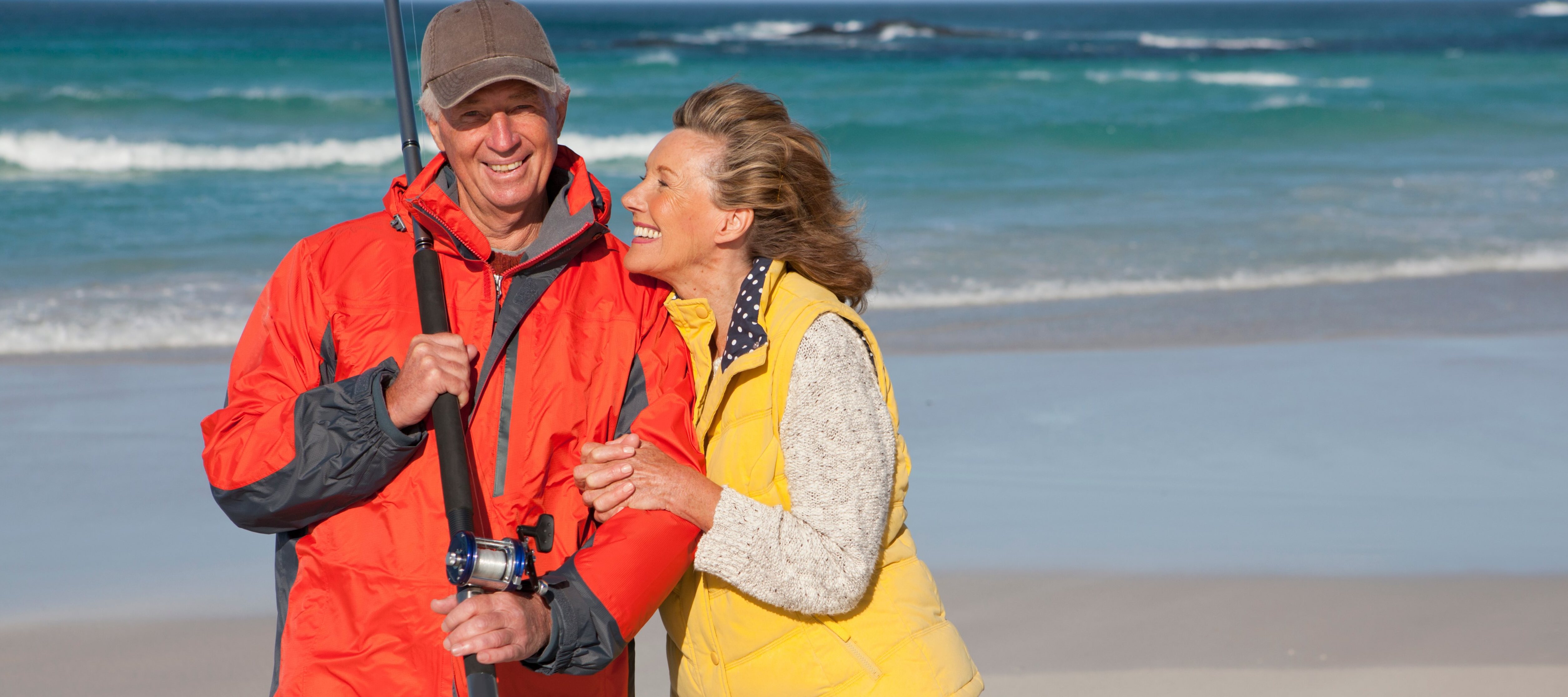 Fisherman and his wife standing on the beach.