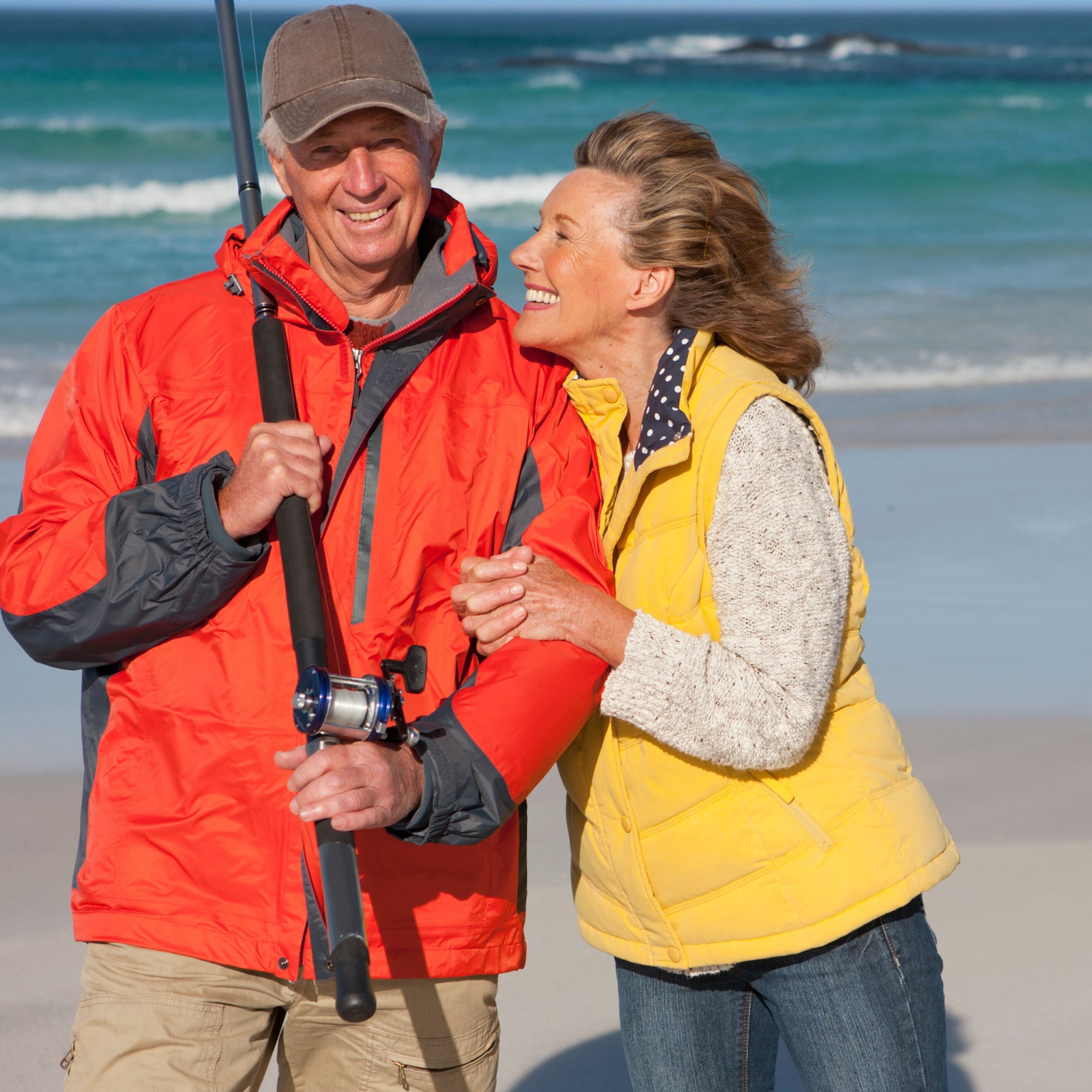 Fisherman and his wife standing on the beach.