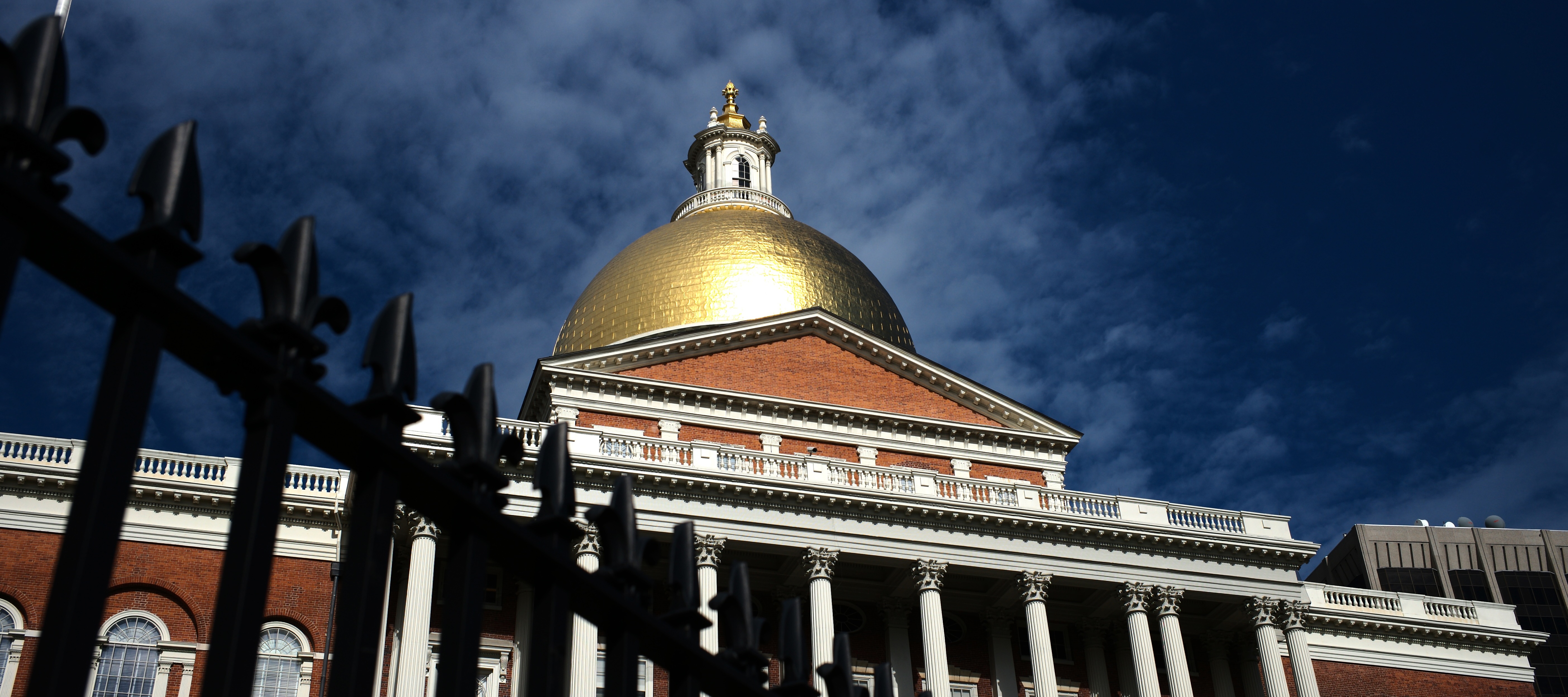 Dark clouds gather over the Massachusetts State House.