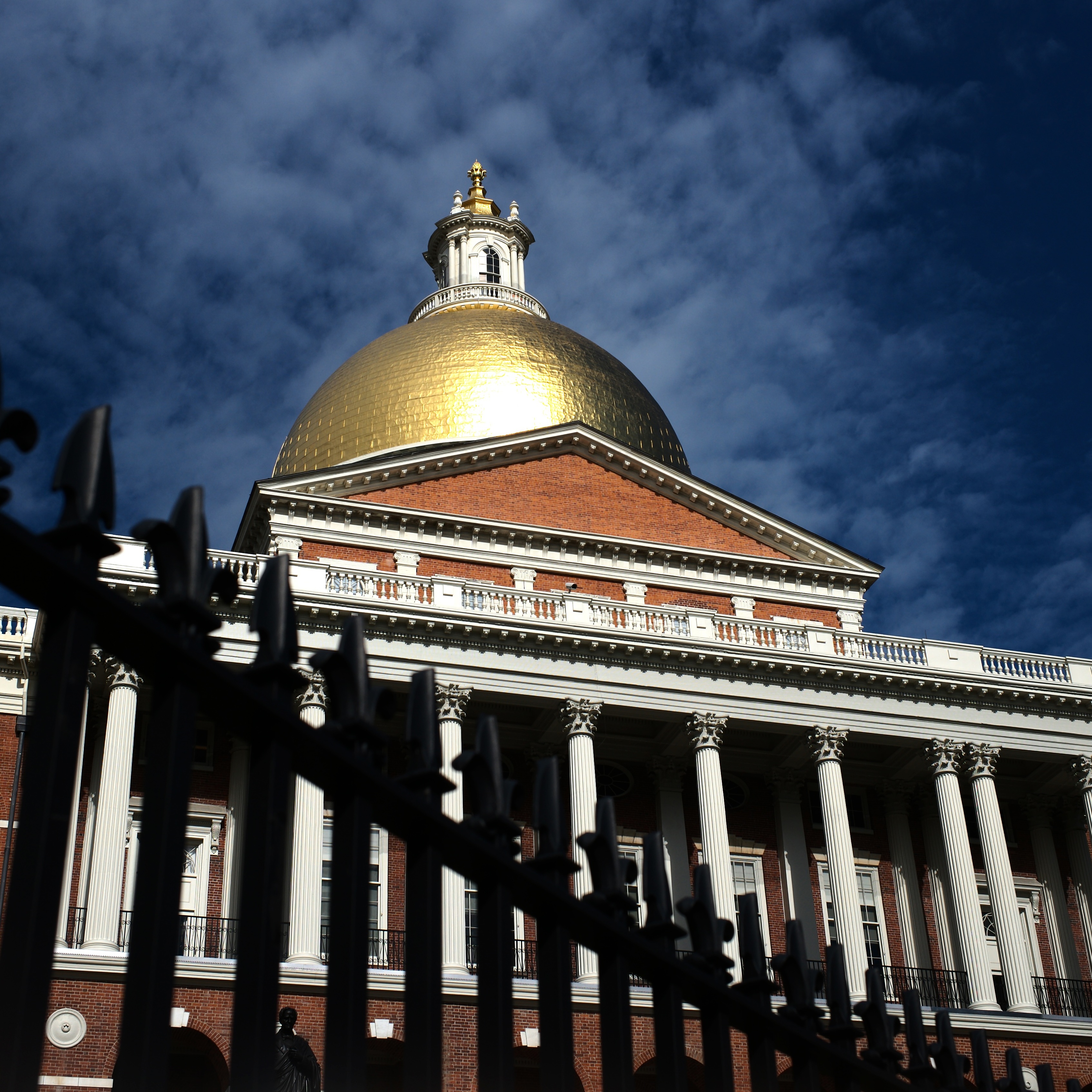 Dark clouds gather over the Massachusetts State House.