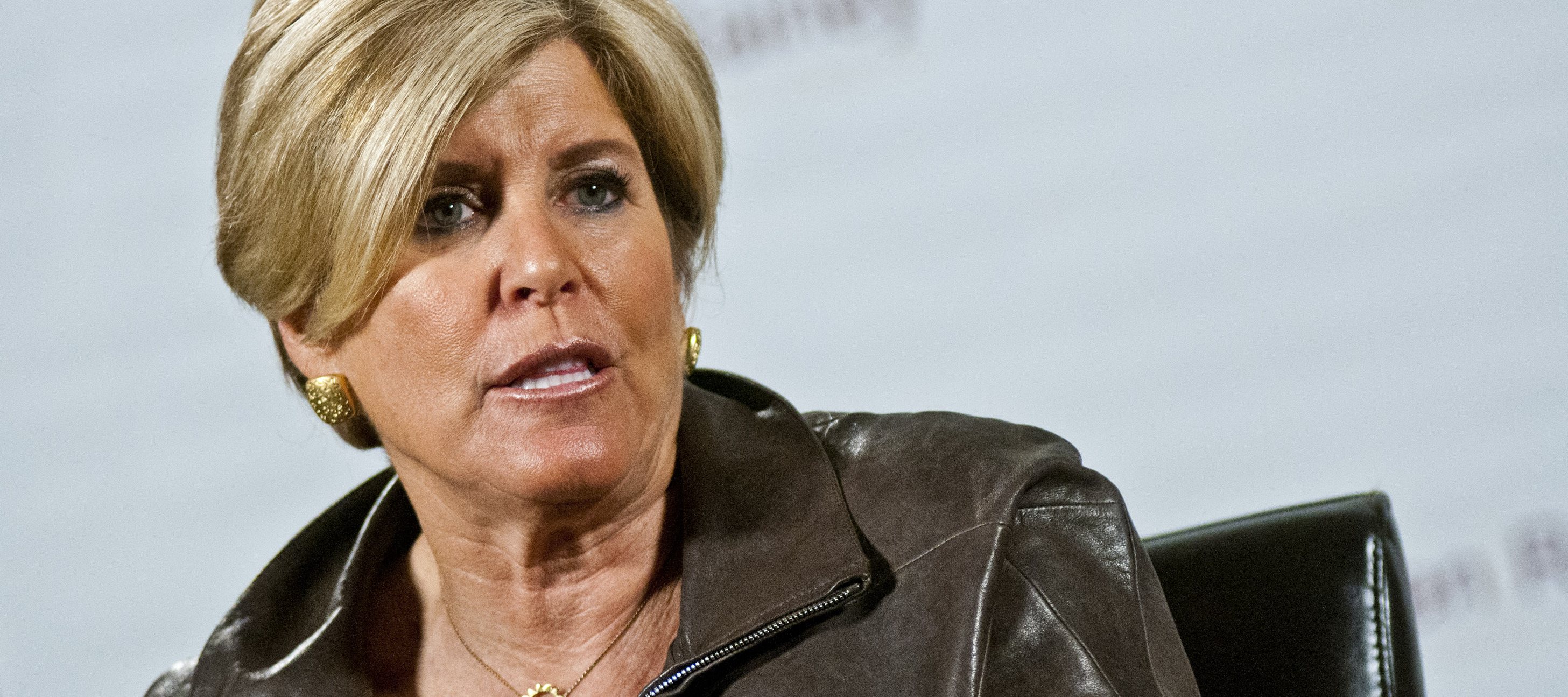 Suze Orman speaking at an event.