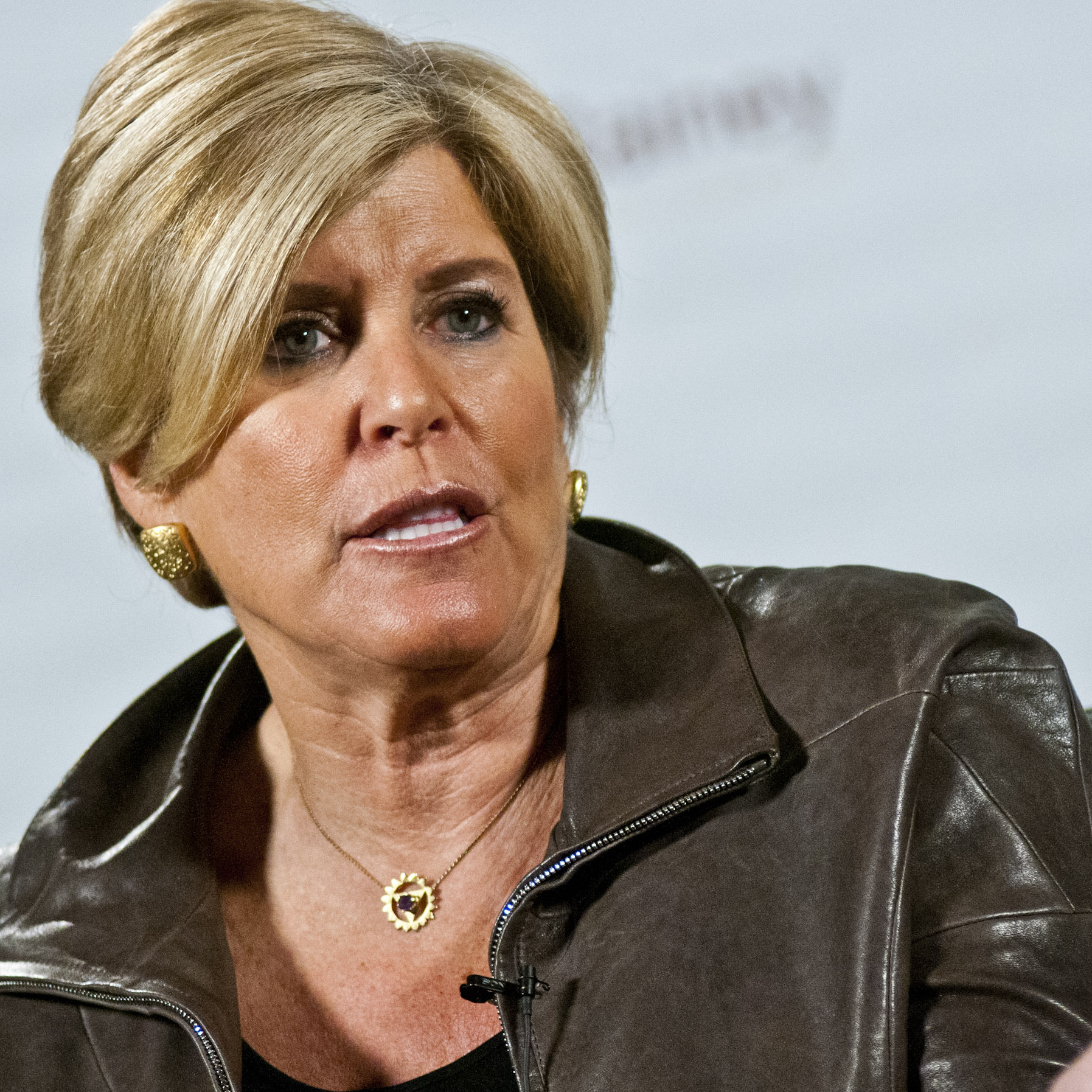 Suze Orman speaking at an event.