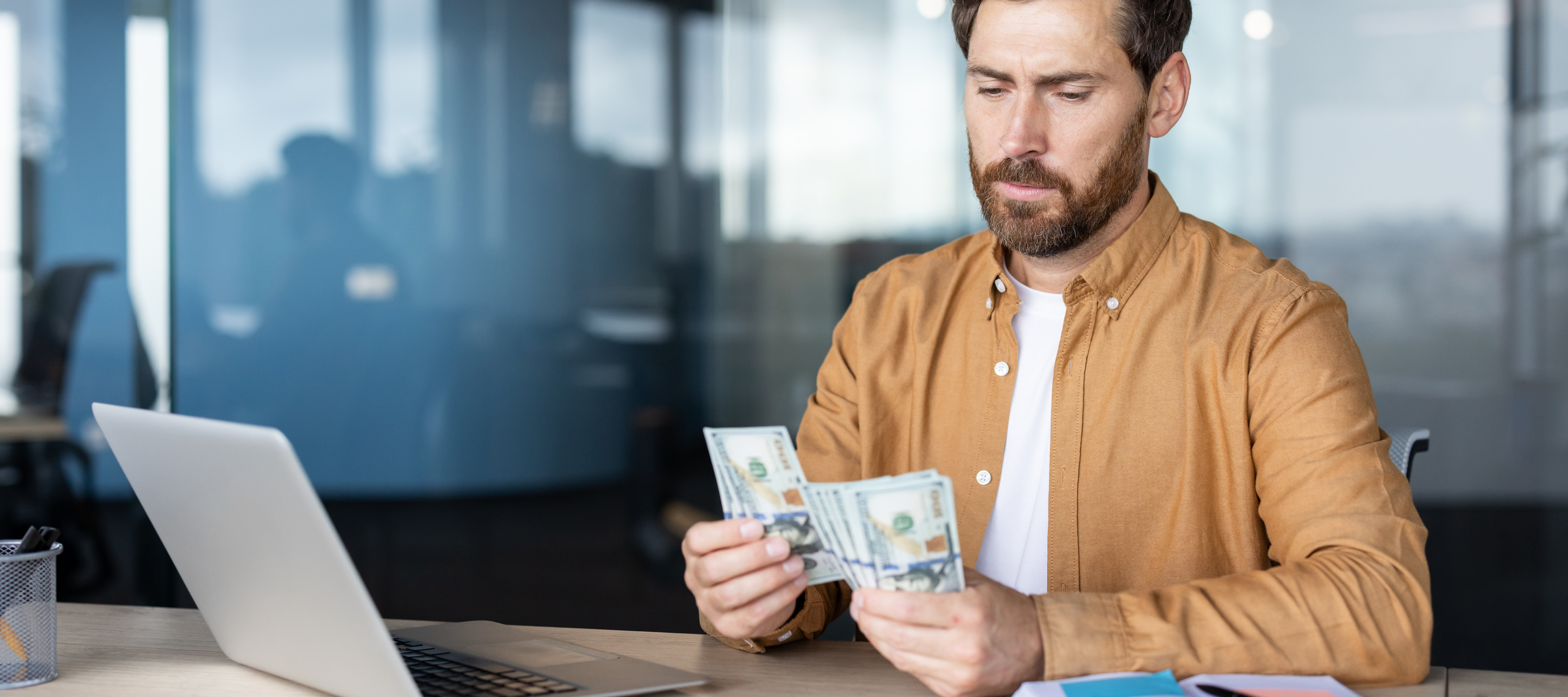 A man counts money at his deck.