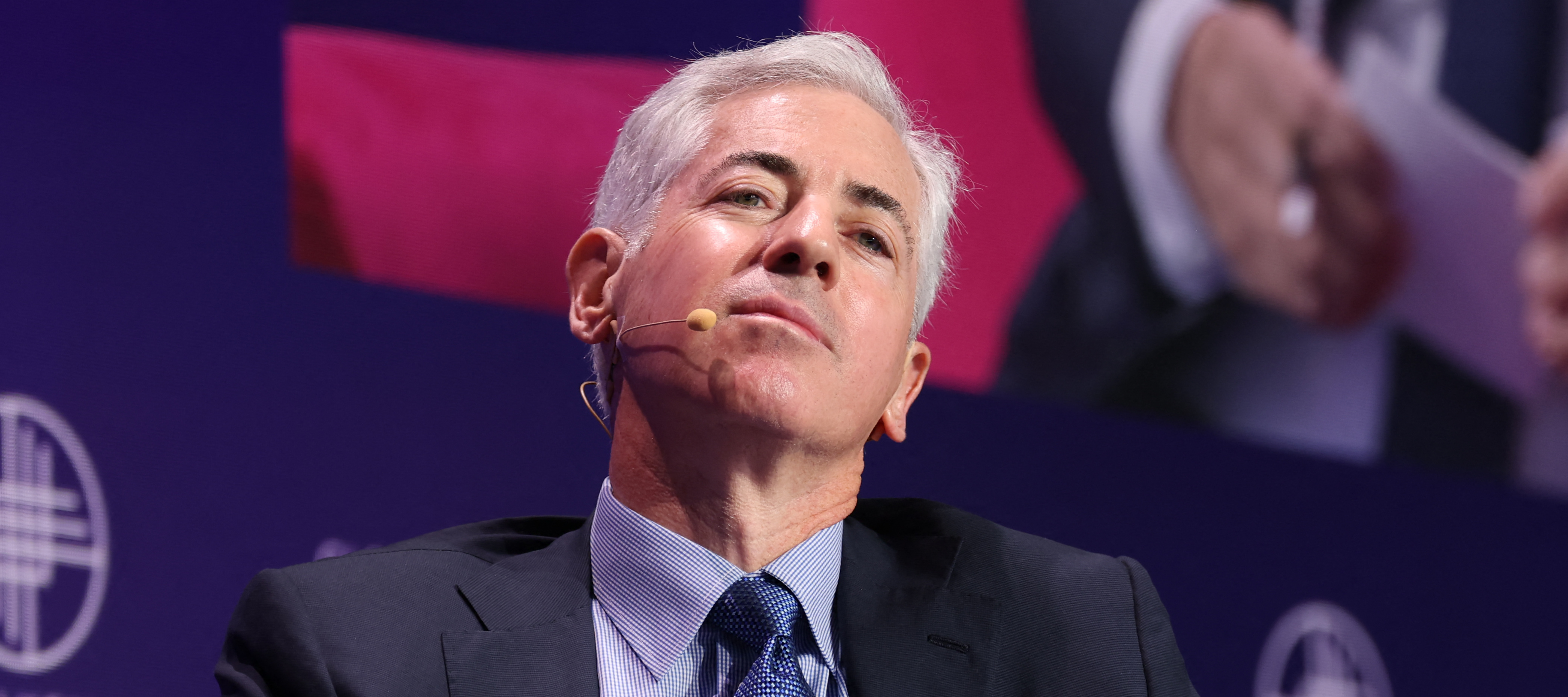 Bill Ackman, Founder and CEO of Pershing Square Capital Management, leans backwards in his chair, looking down at the viewer.