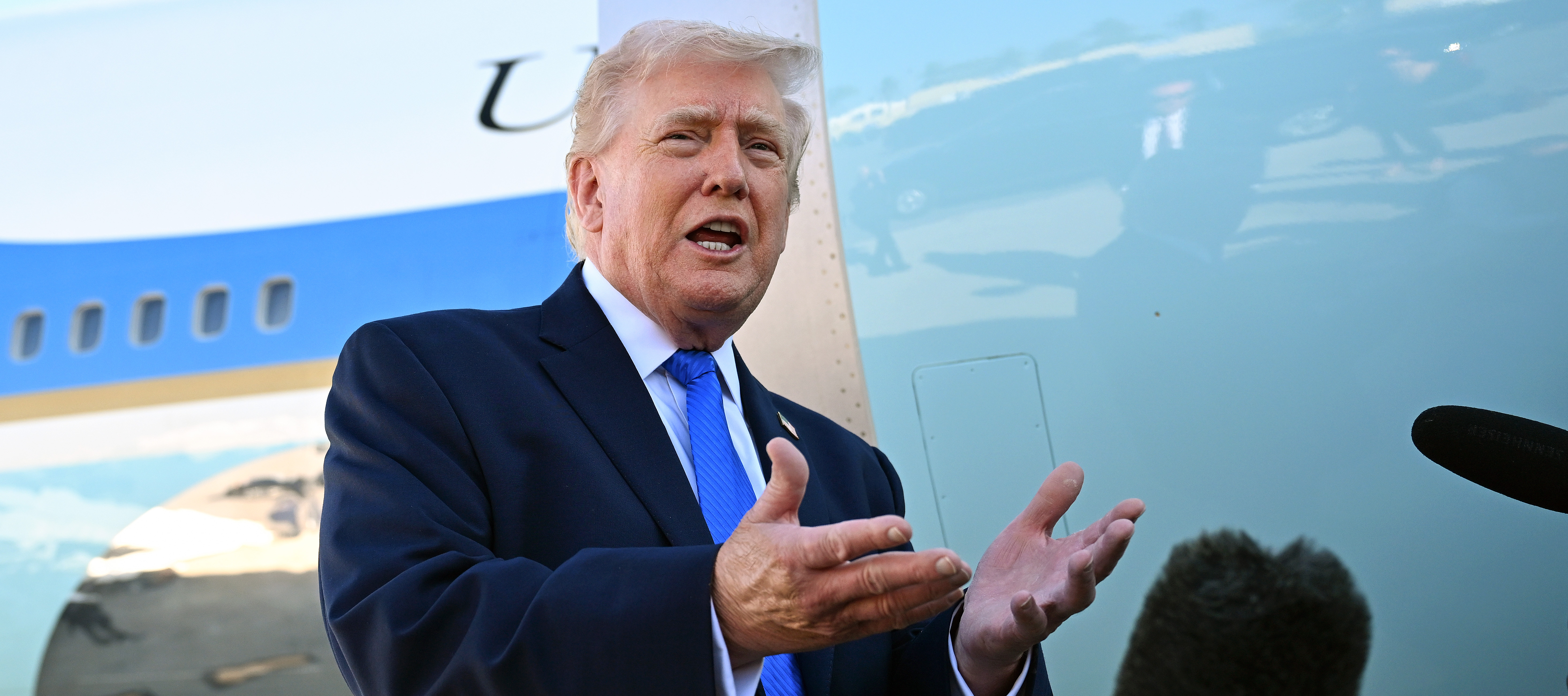 President Donald Trump speaks to reporters before boarding Air Force One at Palm Beach International Airport.