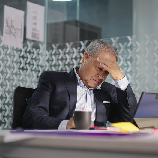 A frustrated older man looks at his computer.