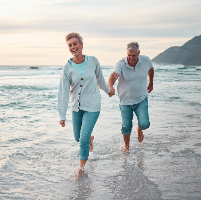 Couple frolicking on the beach