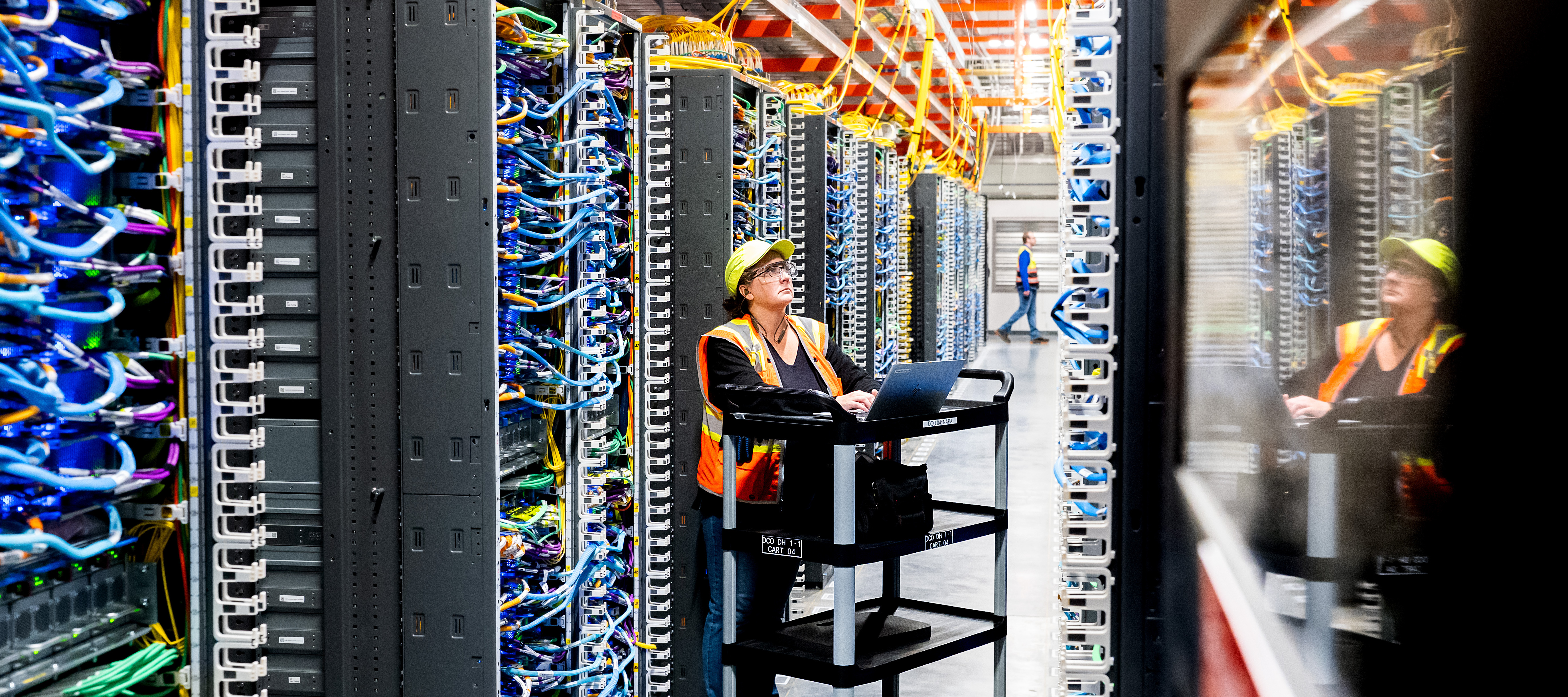 An Amazon Web Services AI data center, where a technician can be seen working, is among hindreds of data centers fueling the need for increased power across the U.S.