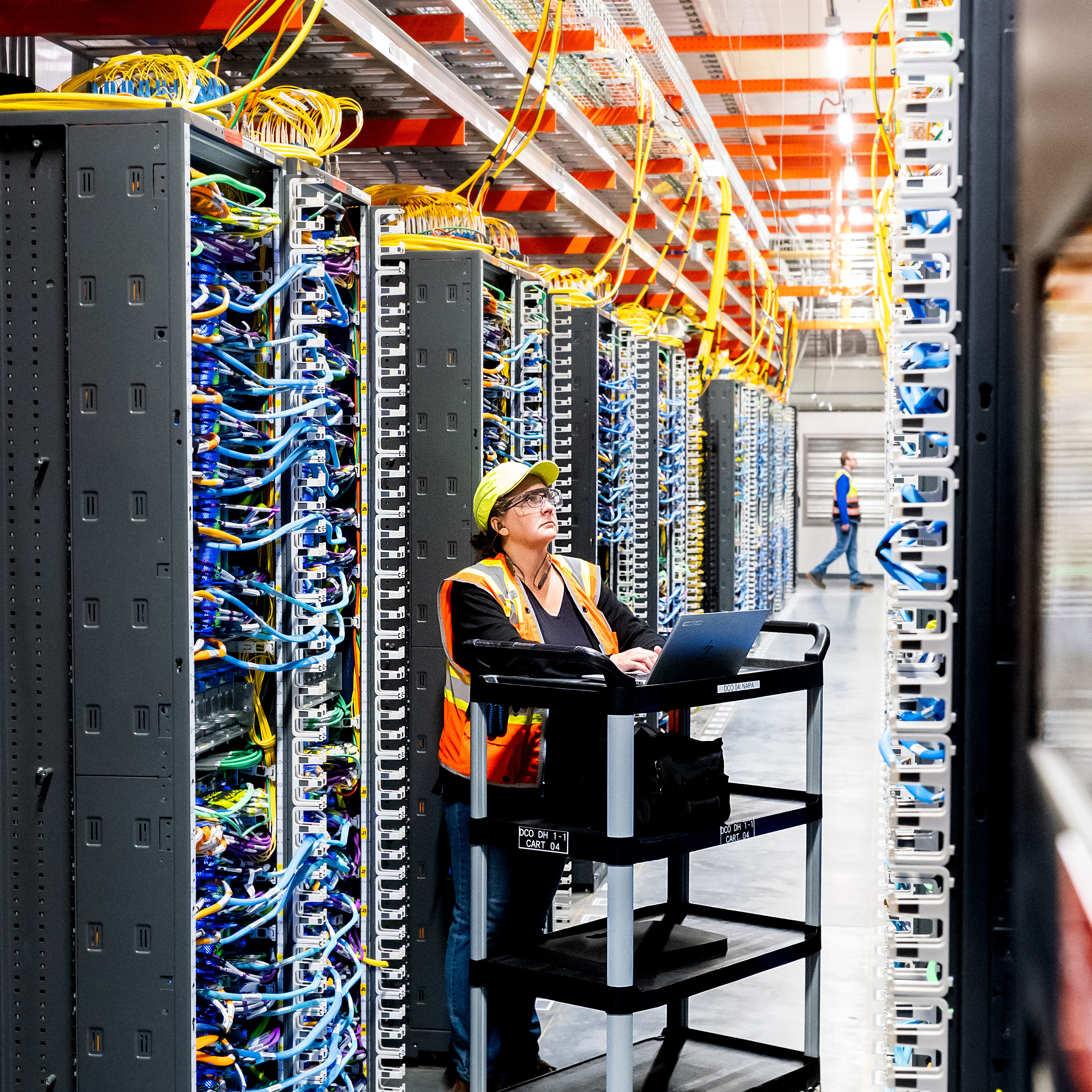 An Amazon Web Services AI data center, where a technician can be seen working, is among hindreds of data centers fueling the need for increased power across the U.S.
