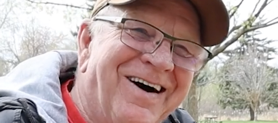 A close up of Dan Simpson smiling while talking about how his stop for a customer's Diet Coke resulted in over $70K of donations for his retirement.