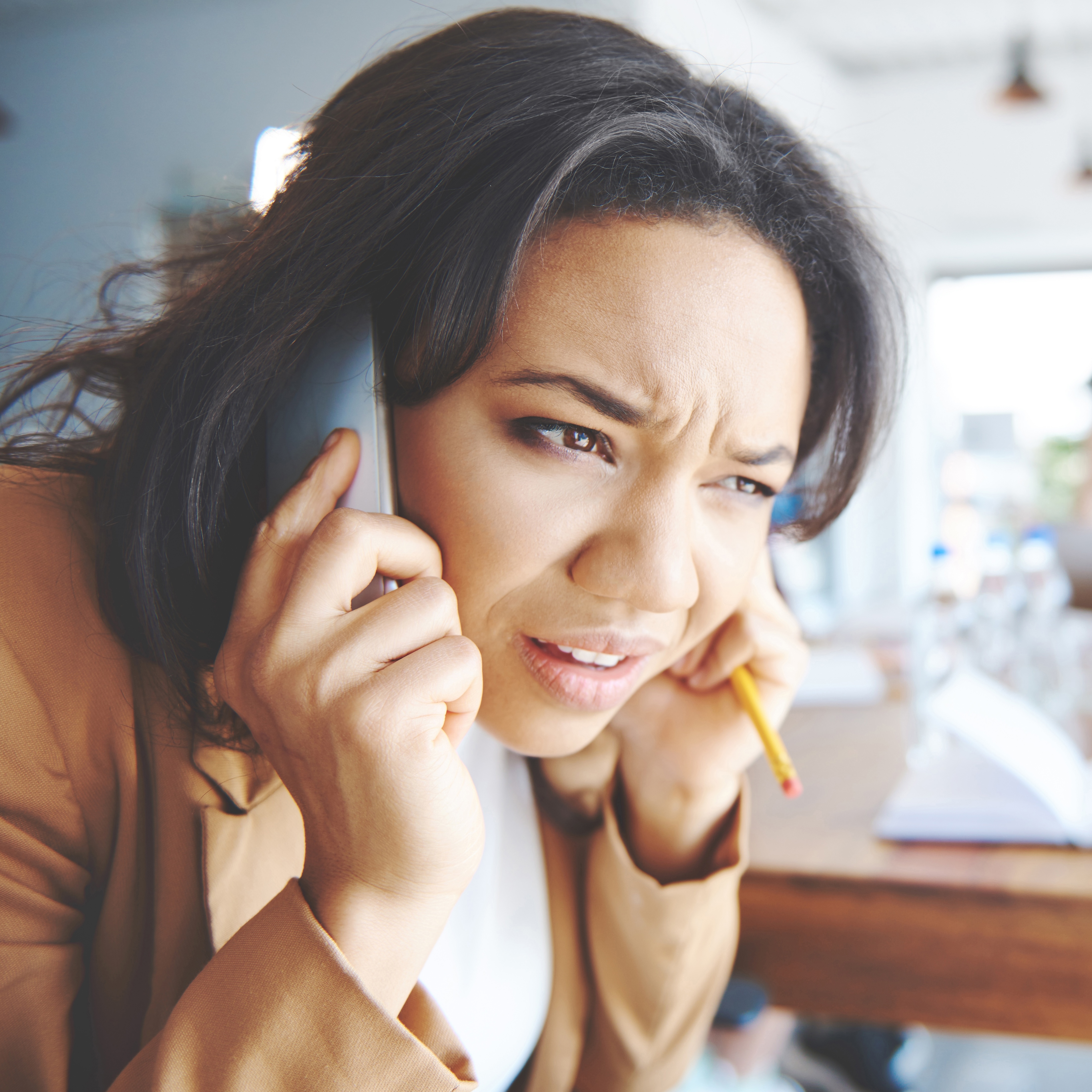 A woman, seen taking a call during a meeting, could be one of many Americans who complain of receiving robocalls as part of the "annoyance economy."