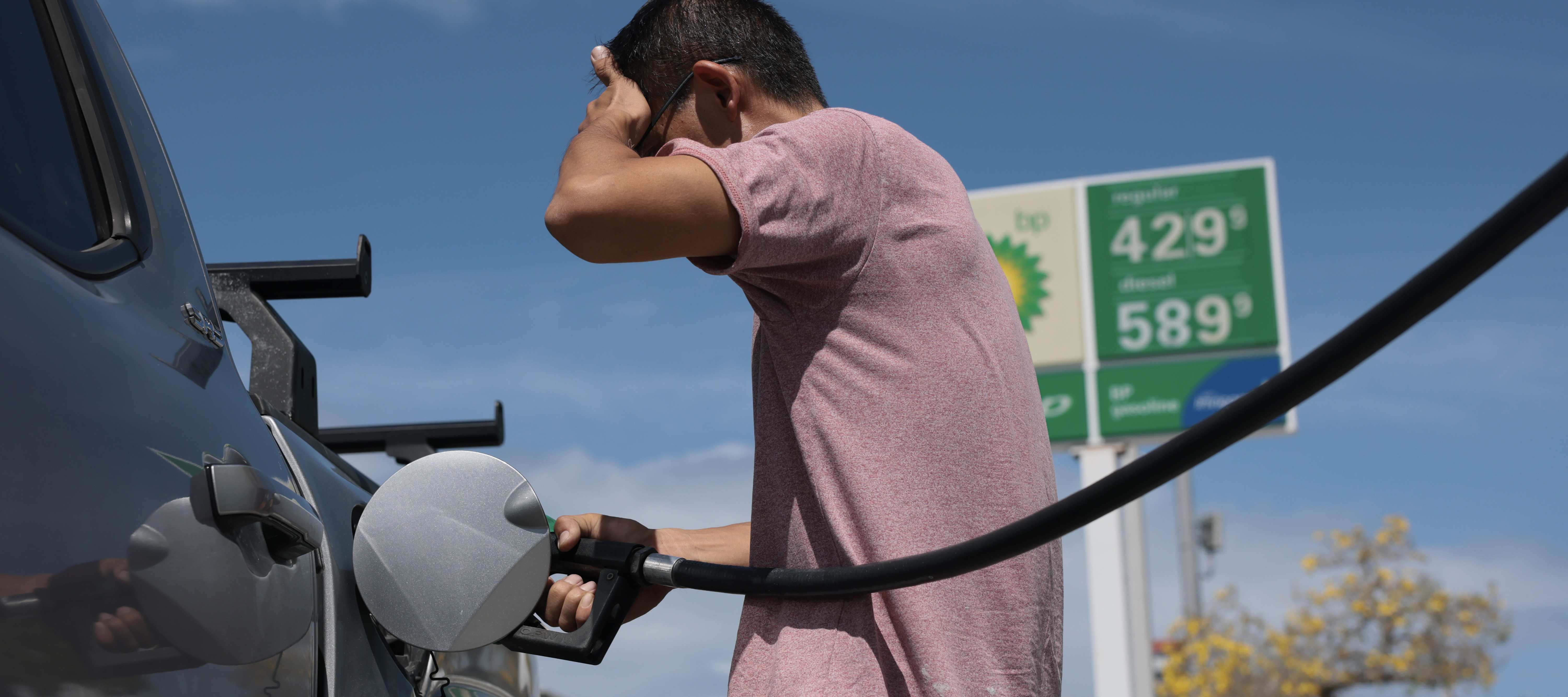 A man fills up his car with gas prices at over $4 a gallon in Miami, Florida.