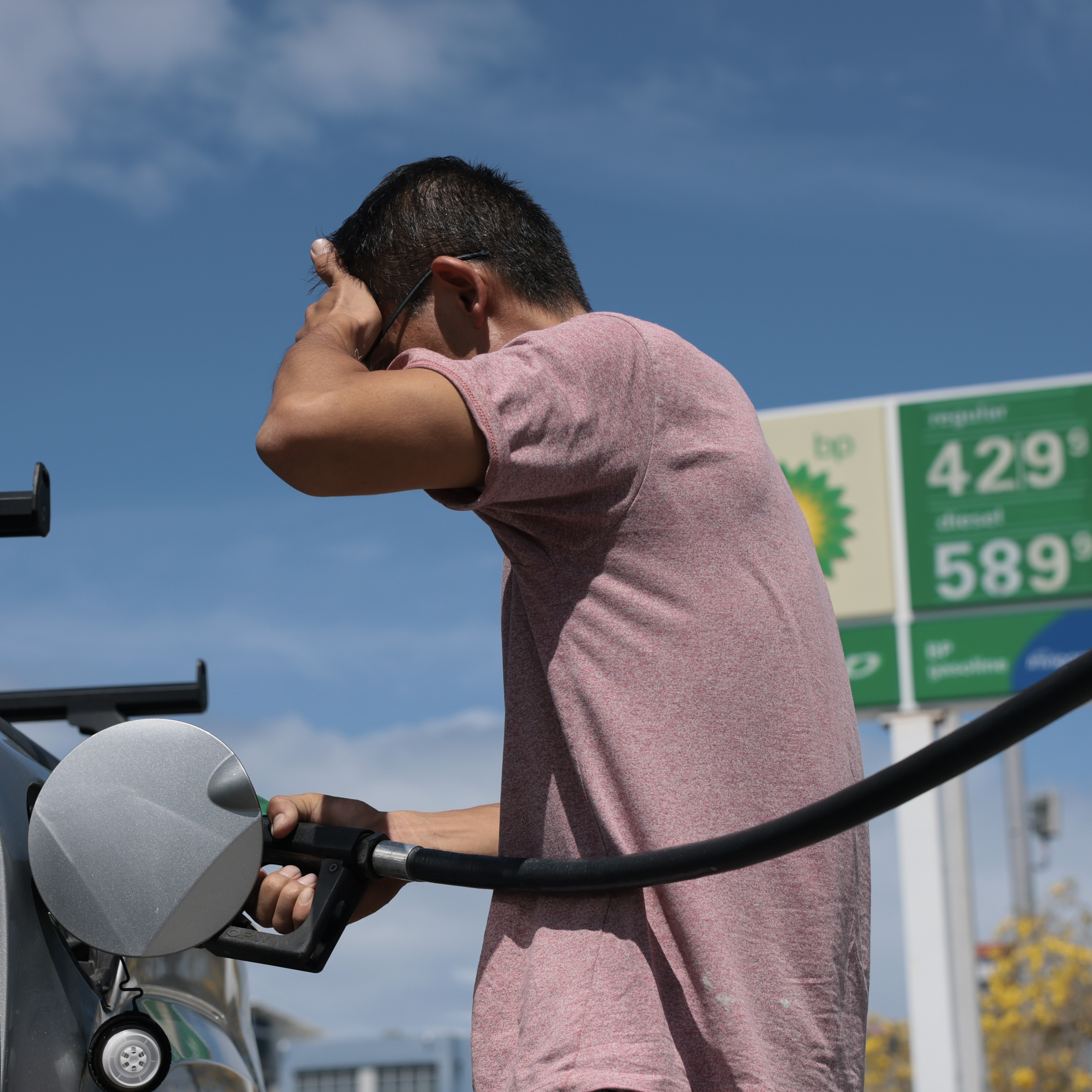 A man fills up his car with gas prices at over $4 a gallon in Miami, Florida.