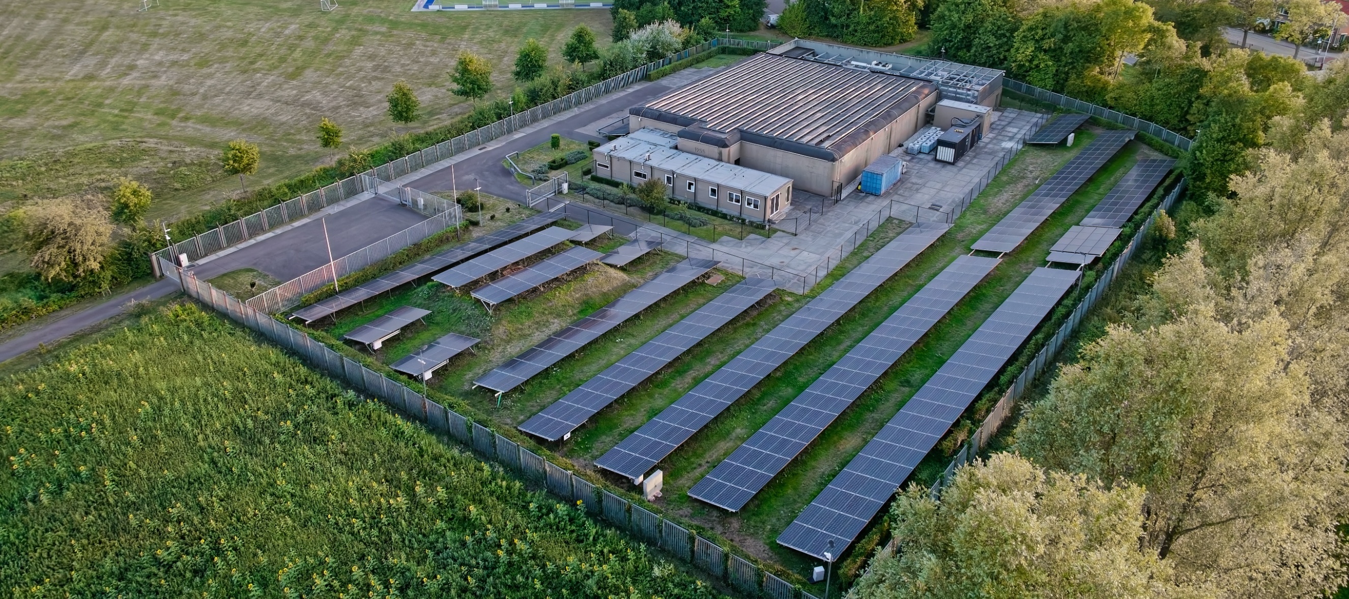 An aerial view of a data center surrounded by lush farmland