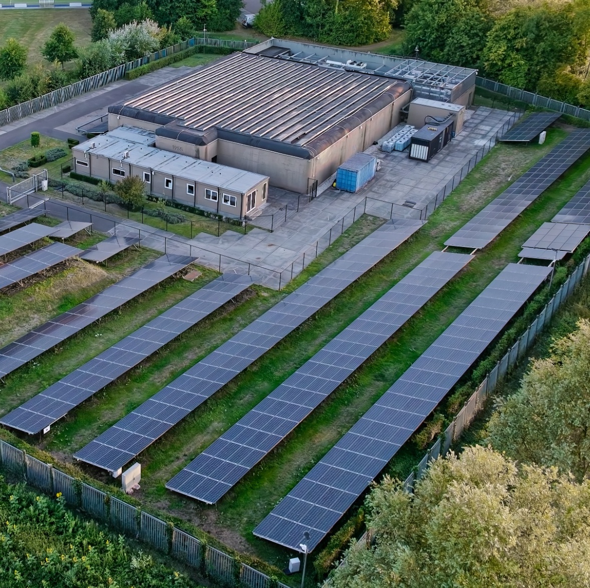 An aerial view of a data center surrounded by lush farmland