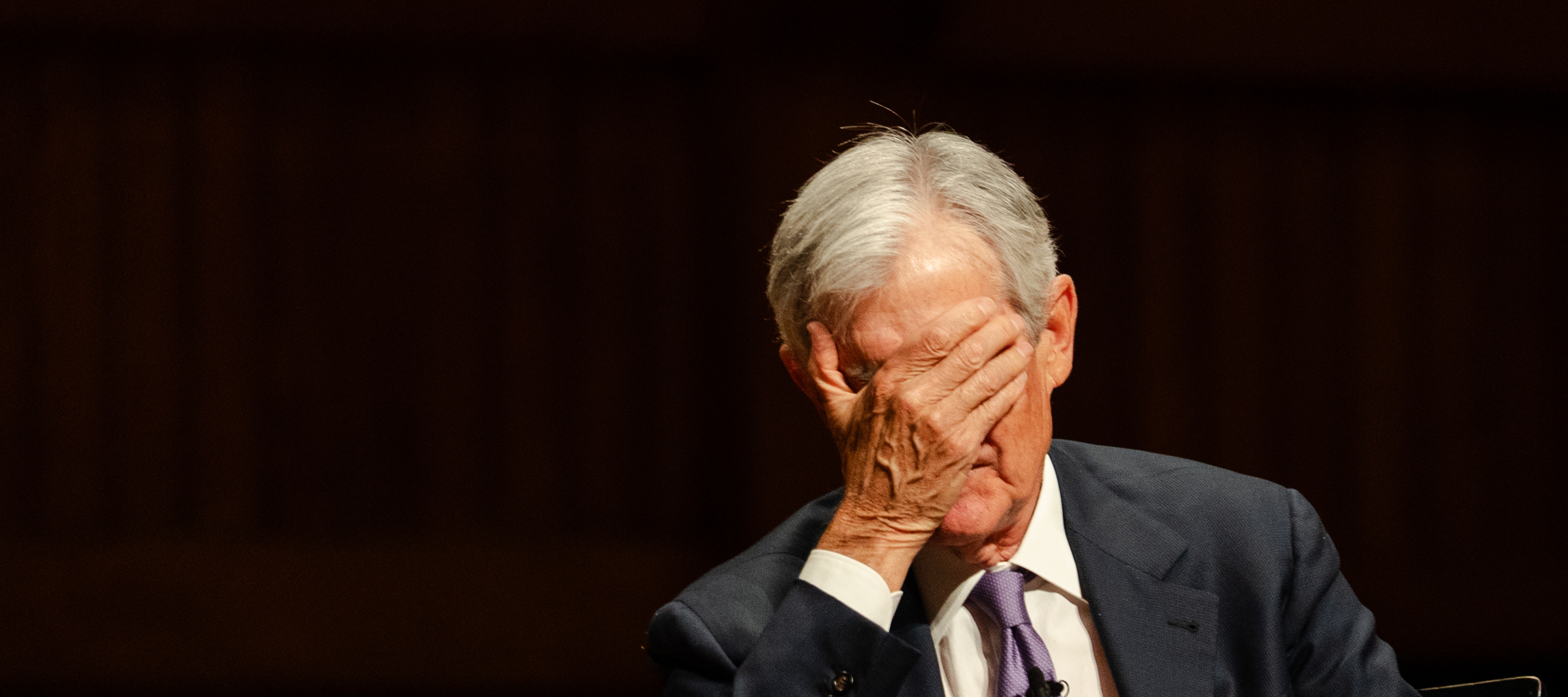 Federal Reserve Chairman Jerome Powell covers his face while answering a question during a Principles of Economics class at Harvard University on March 30 in Cambridge, Massachusetts.