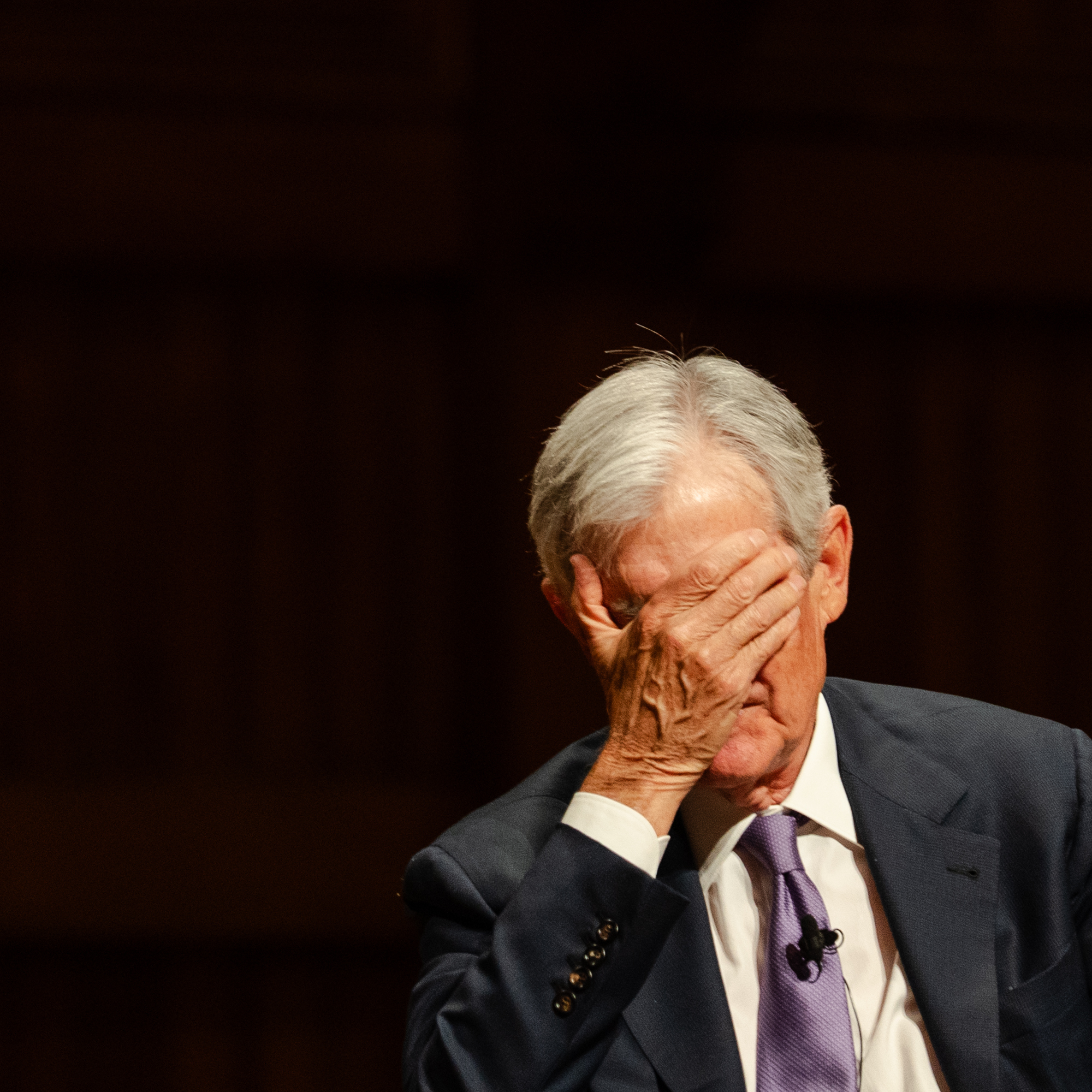 Federal Reserve Chairman Jerome Powell covers his face while answering a question during a Principles of Economics class at Harvard University on March 30 in Cambridge, Massachusetts.