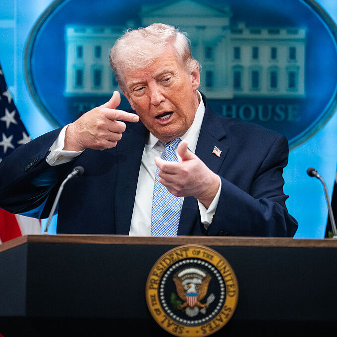 President Donald Trump mimics firing a gun during a White House news conference about the war on Iran.