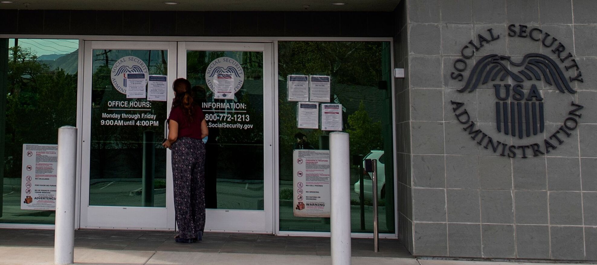 A woman stands outside a US Social Security Administration building in Burbank, California.