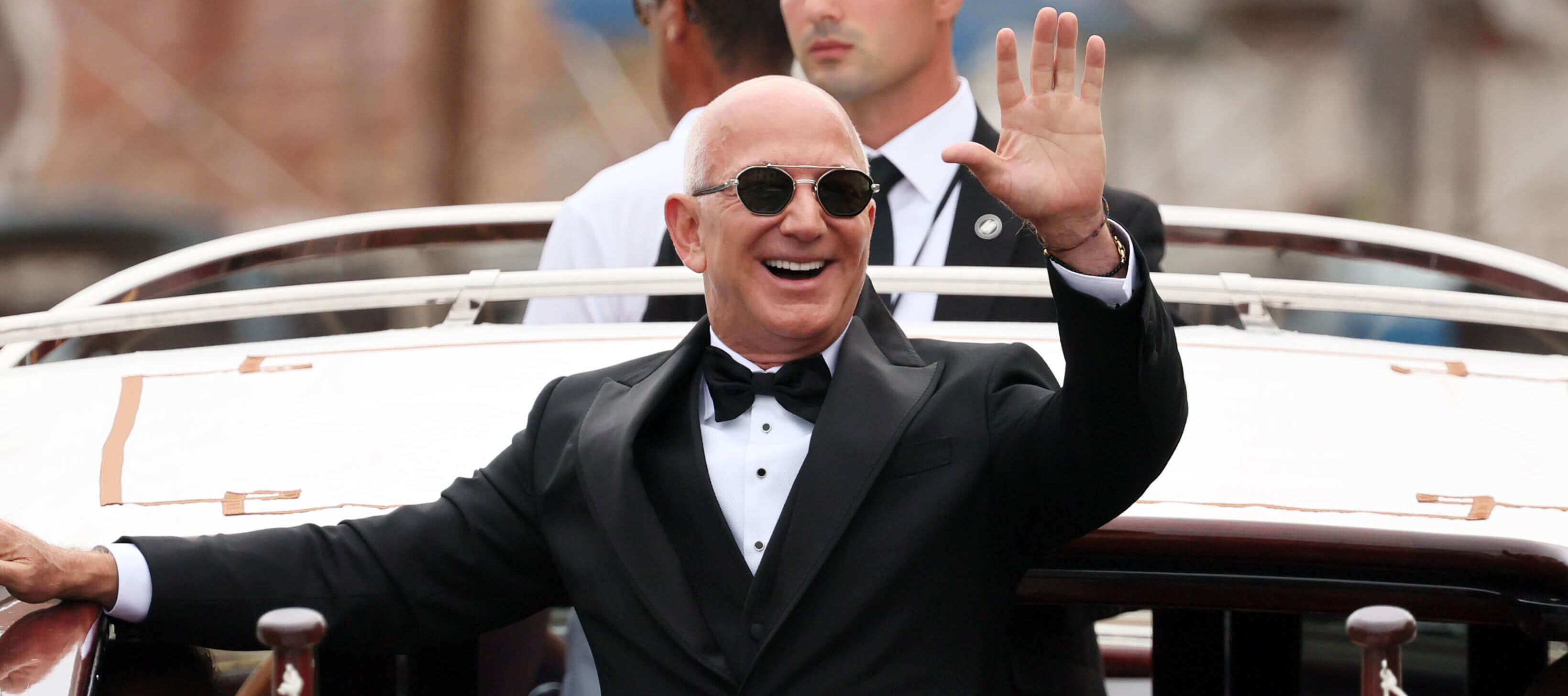Jeff Bezos waves to cameras at his wedding