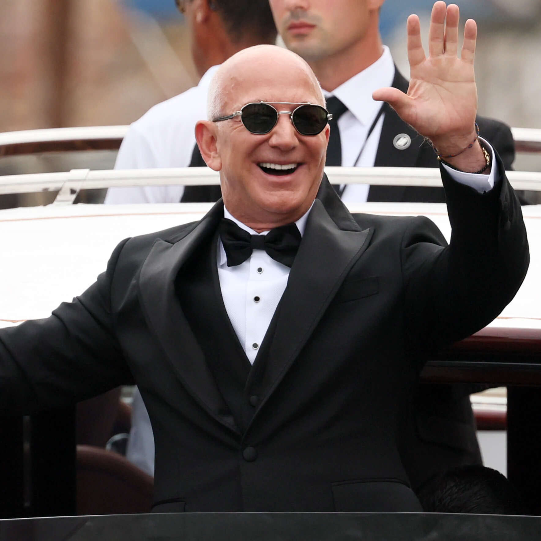 Jeff Bezos waves to cameras at his wedding