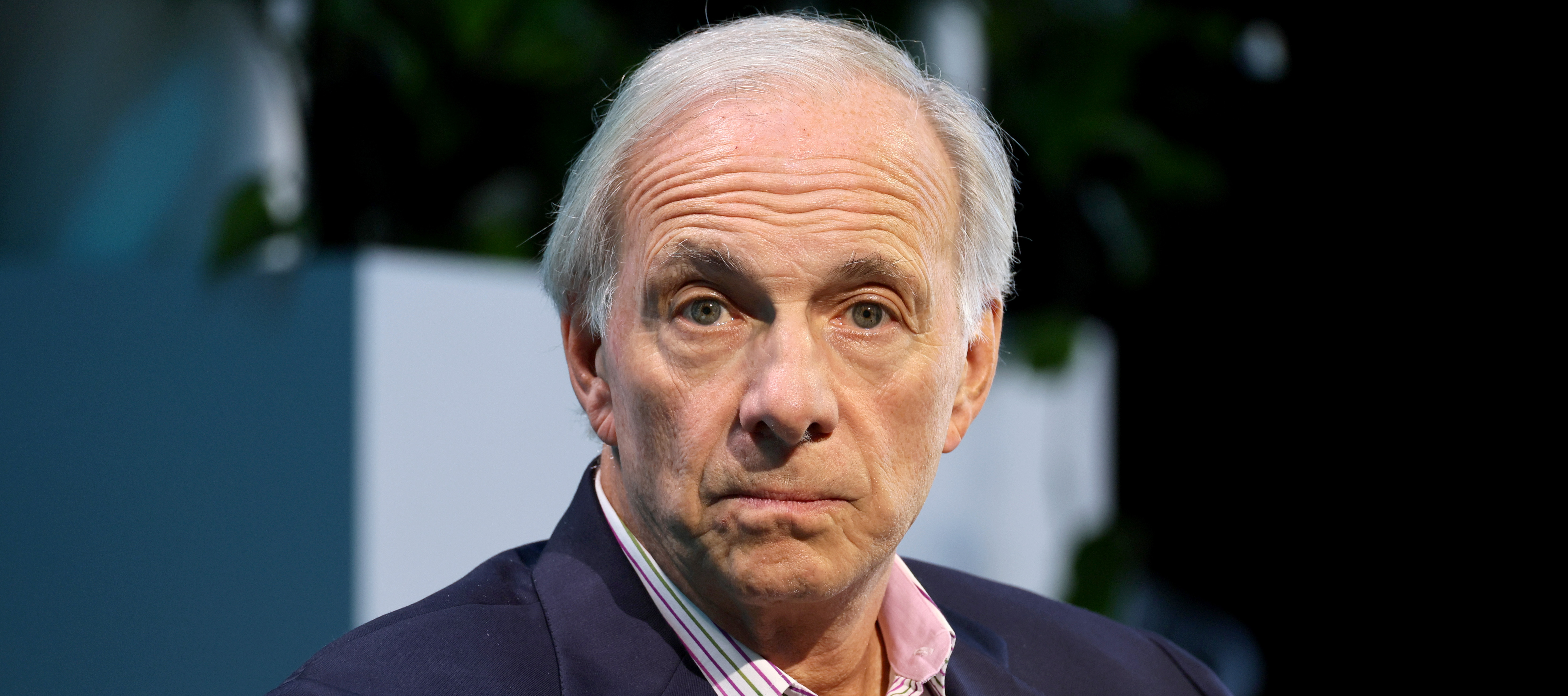 Ray Dalio stares directly at the camera, almost expressionless and entirely still.