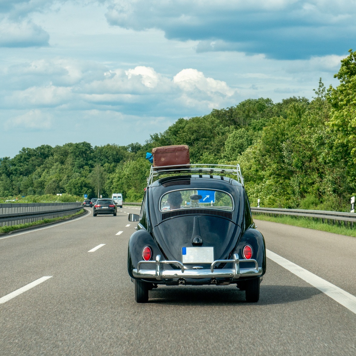 A VW bug driving down a highway