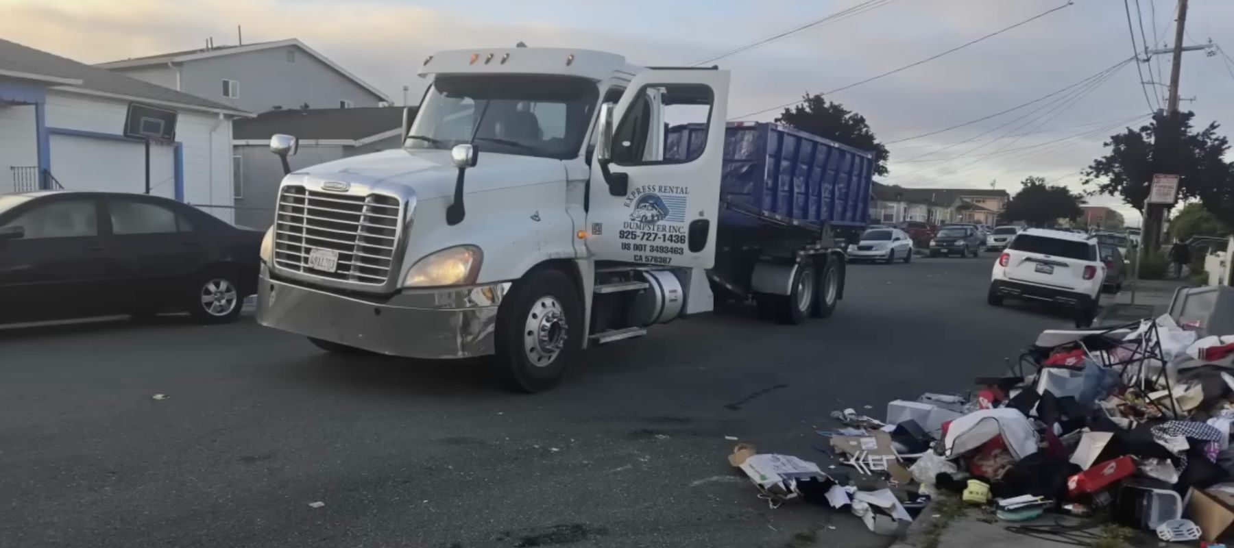 Truck dumping garbage on driveway