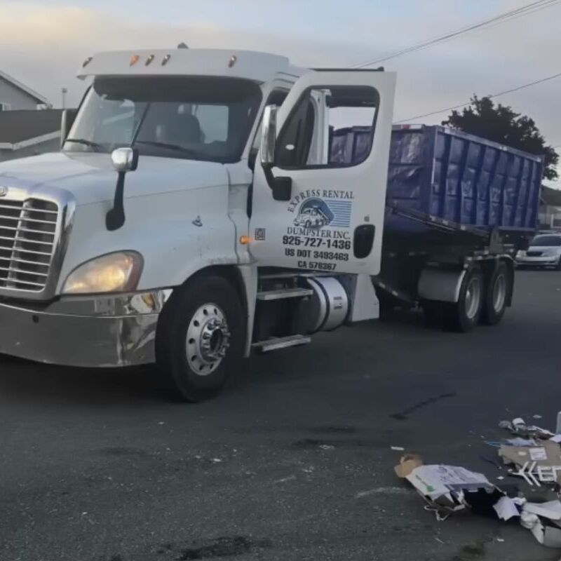 Truck dumping garbage on driveway