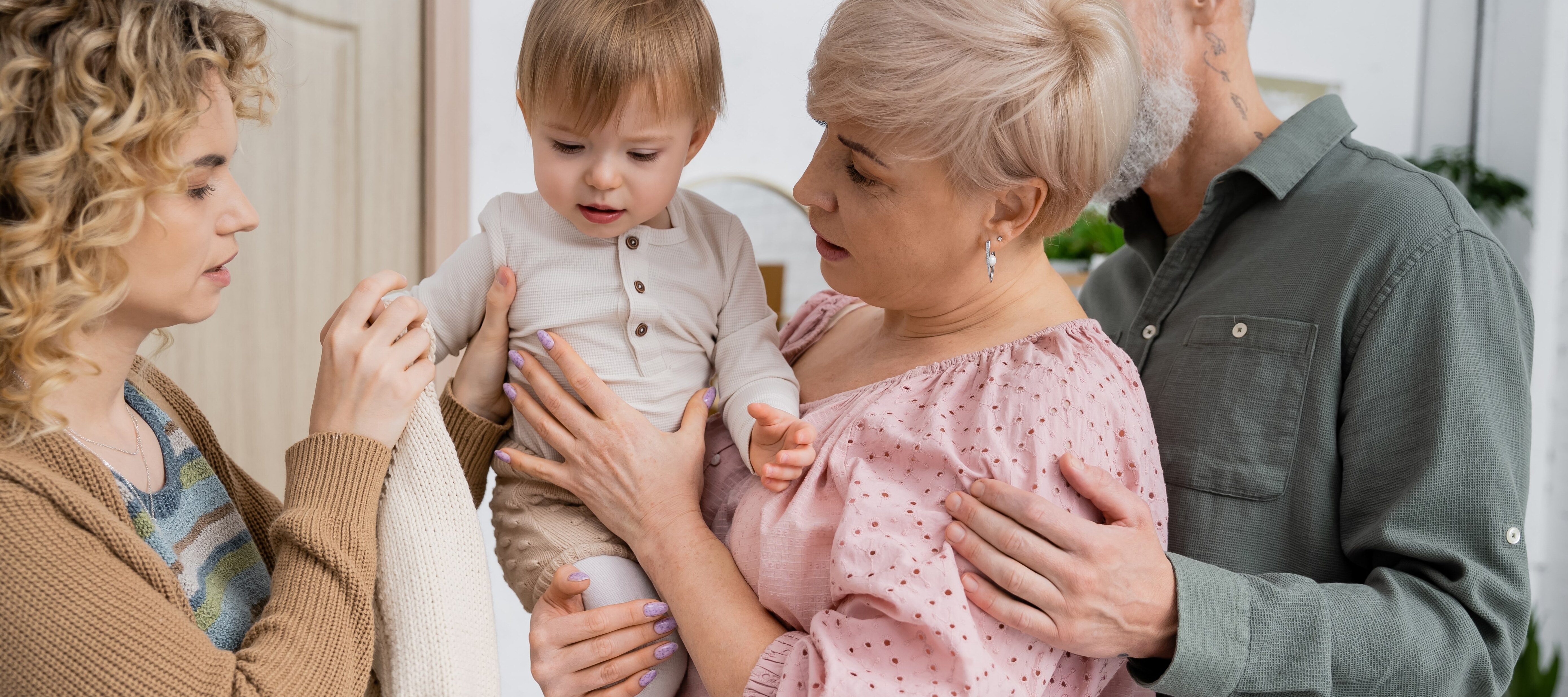 Grandma, mom and toddler smiling together