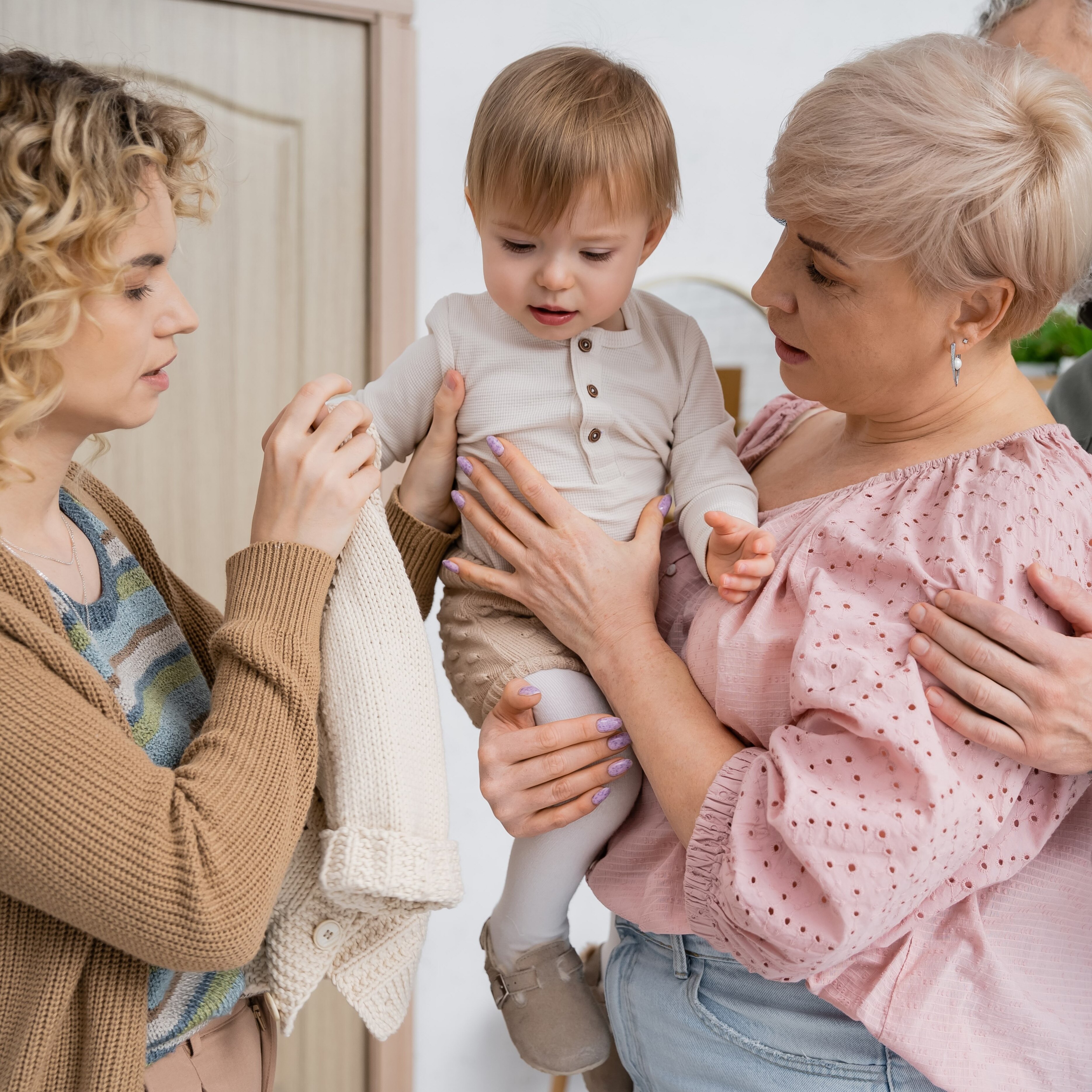 Grandma, mom and toddler smiling together