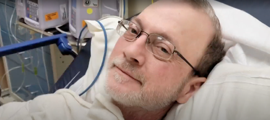 Eric Tennant, seen here in hospital before his death, had been a candidate for a relatively new treatment that was denied four times by his insurer.