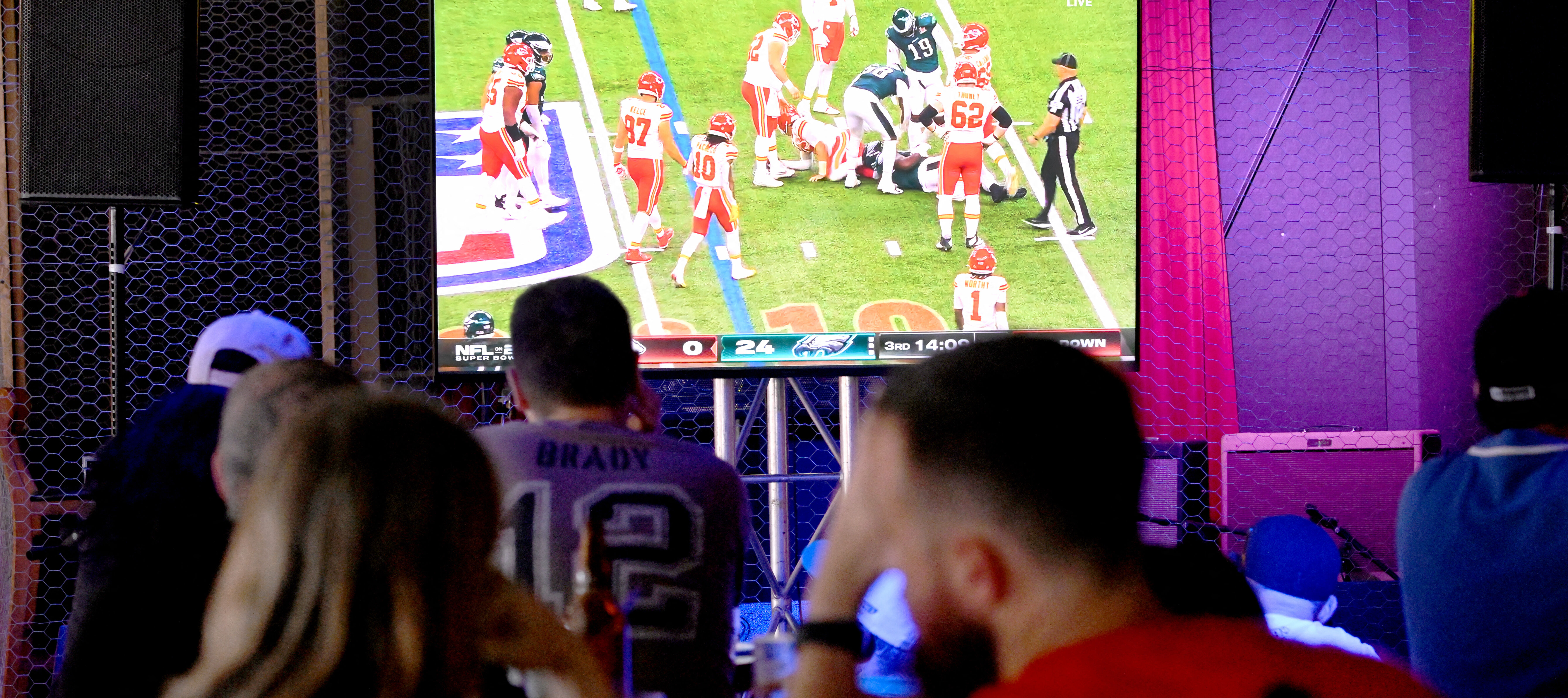 Fans watch the broadcast of the NFL Super Bowl on February 8, 2026.