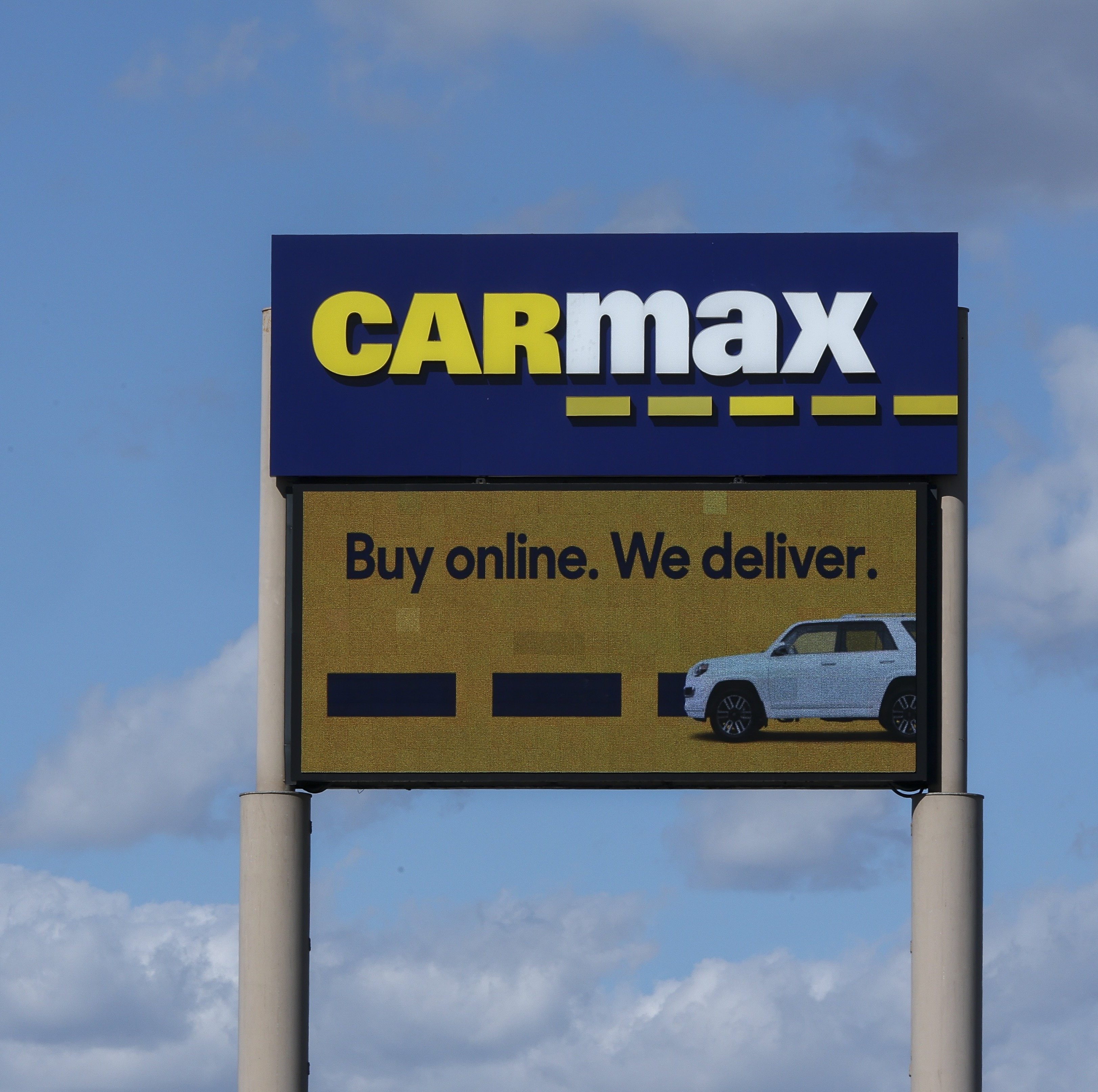 A detail view of CarMax signage is in Inglewood, California