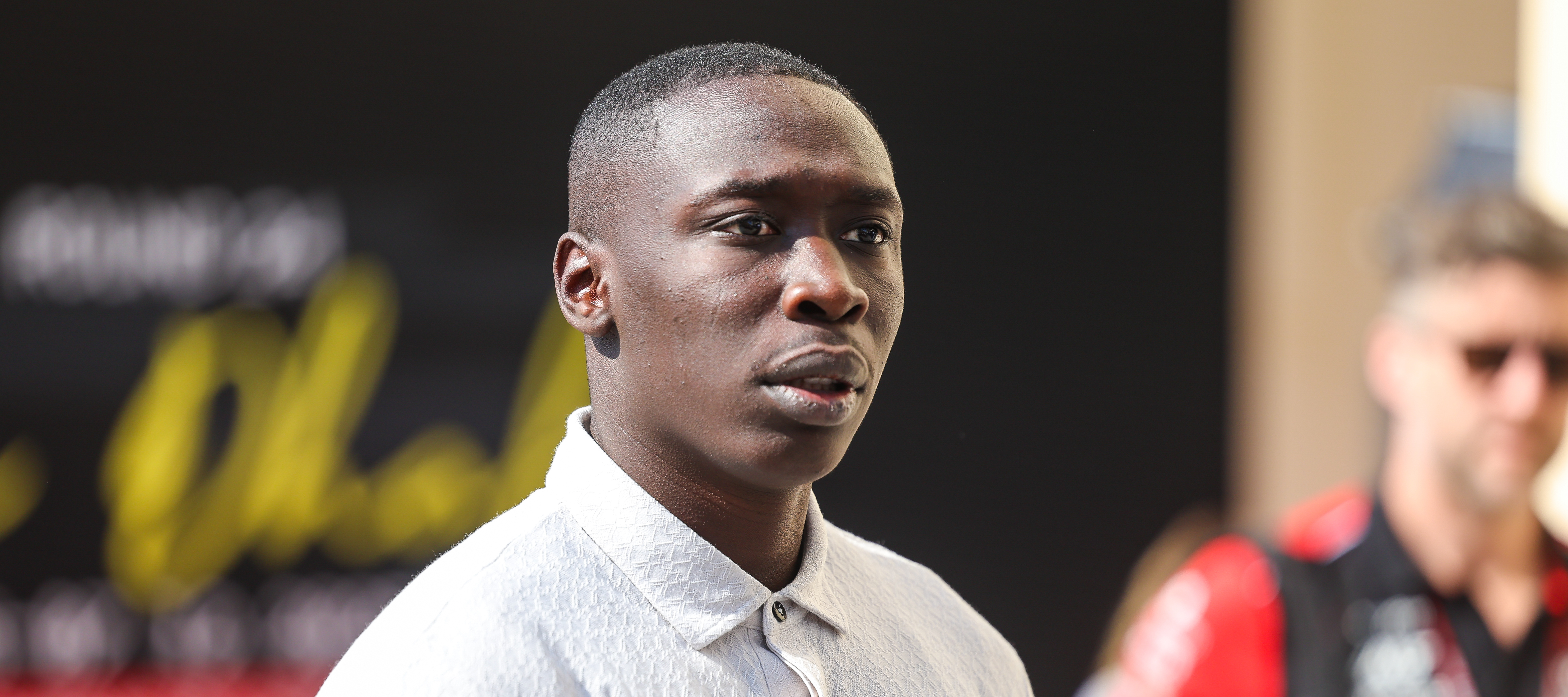 Top TikTok creator Khaby Lame looks surprised as he gazes off into the distance.