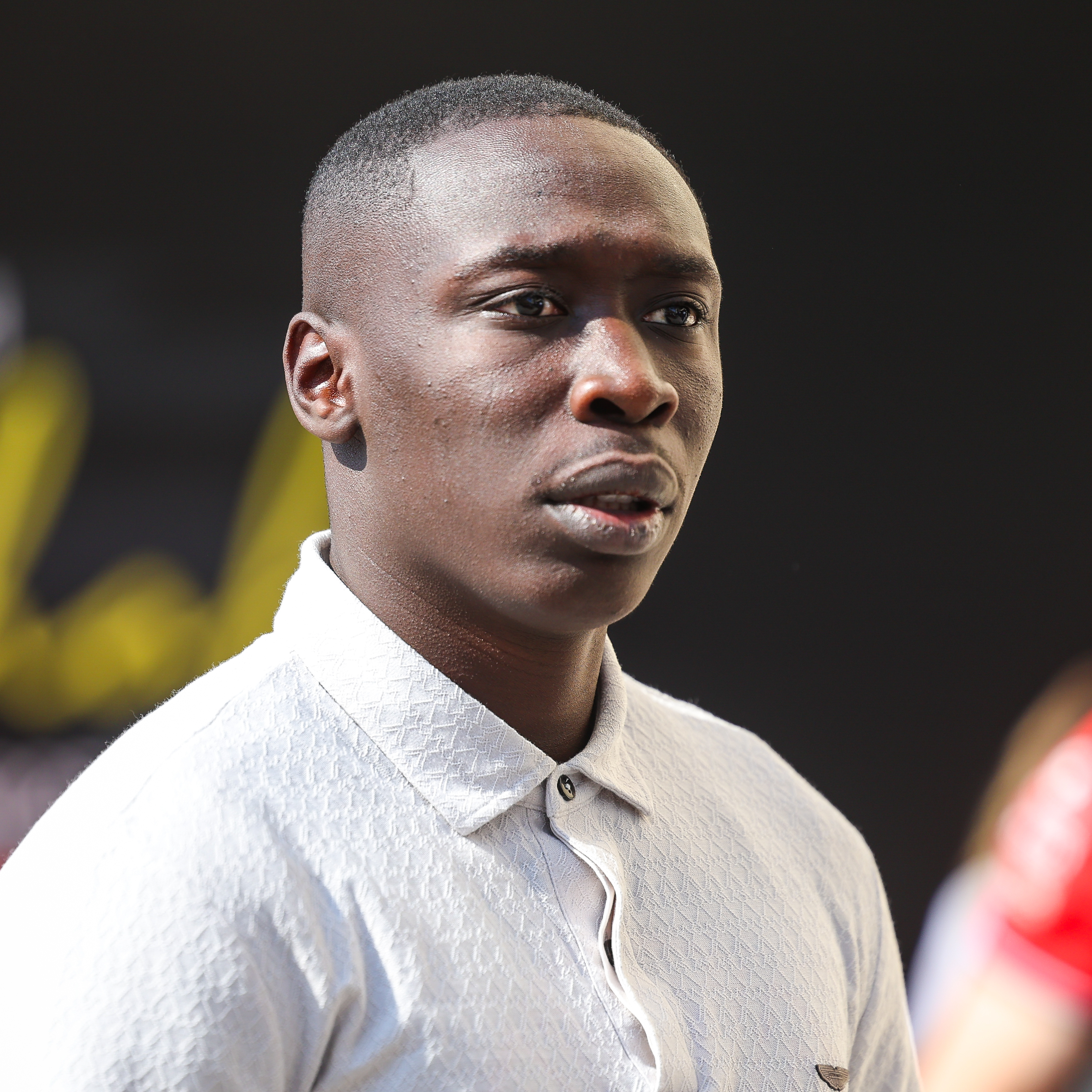 Top TikTok creator Khaby Lame looks surprised as he gazes off into the distance.