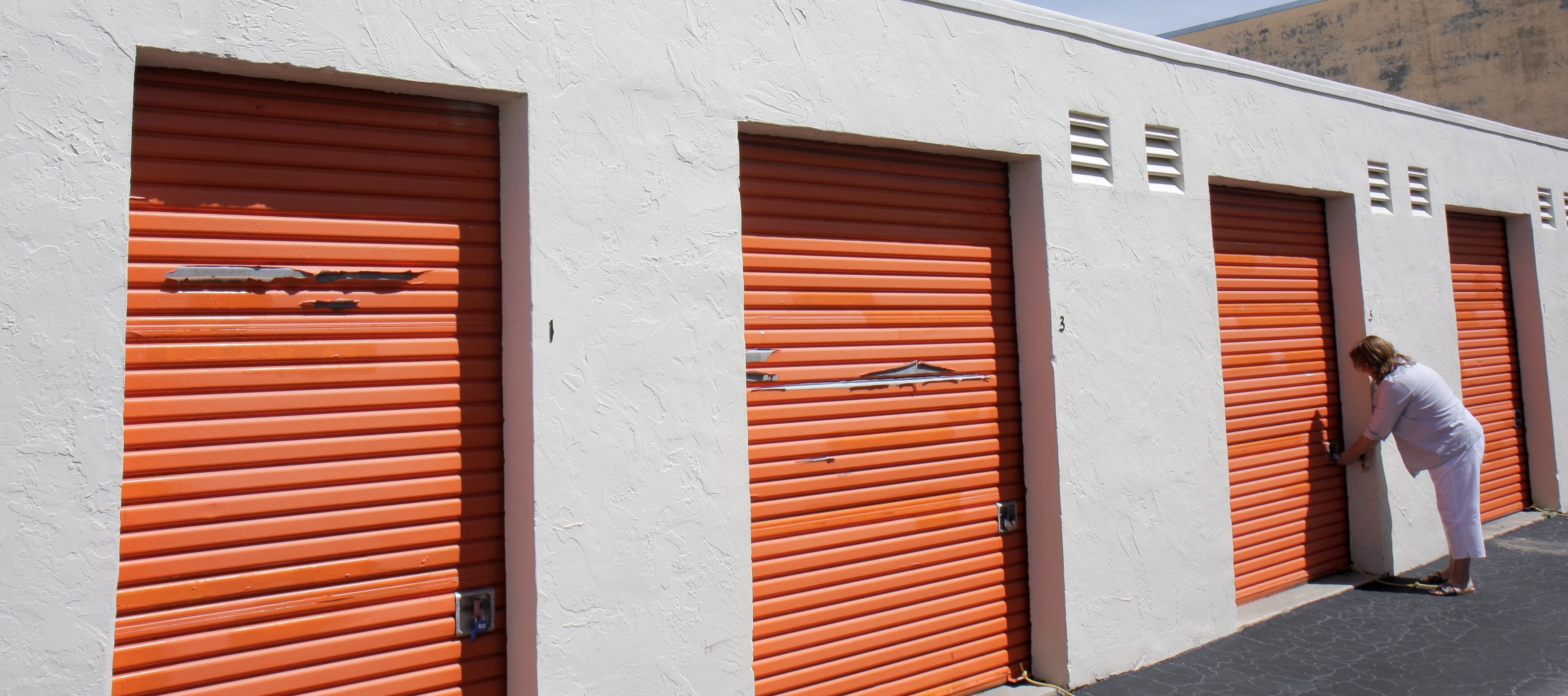 A woman unlocking a unit at Public Storage.